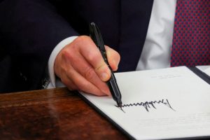 Trump signs executive order and pardons defendants on January 6 in the Oval Office of the White House