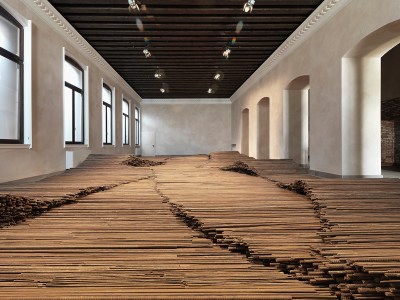 A series of metal rods assembled to form an installation on a floor.