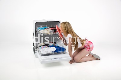A woman leaned over a dishwasher that has flip-flops in its racks. She holds one flip-flop to her nose. Superimposed over her is text reading 'disimages.'