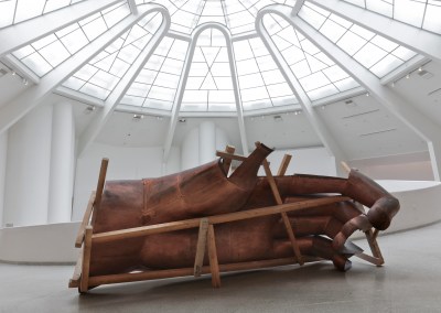 A large sculpture of a hand inside a support structure.