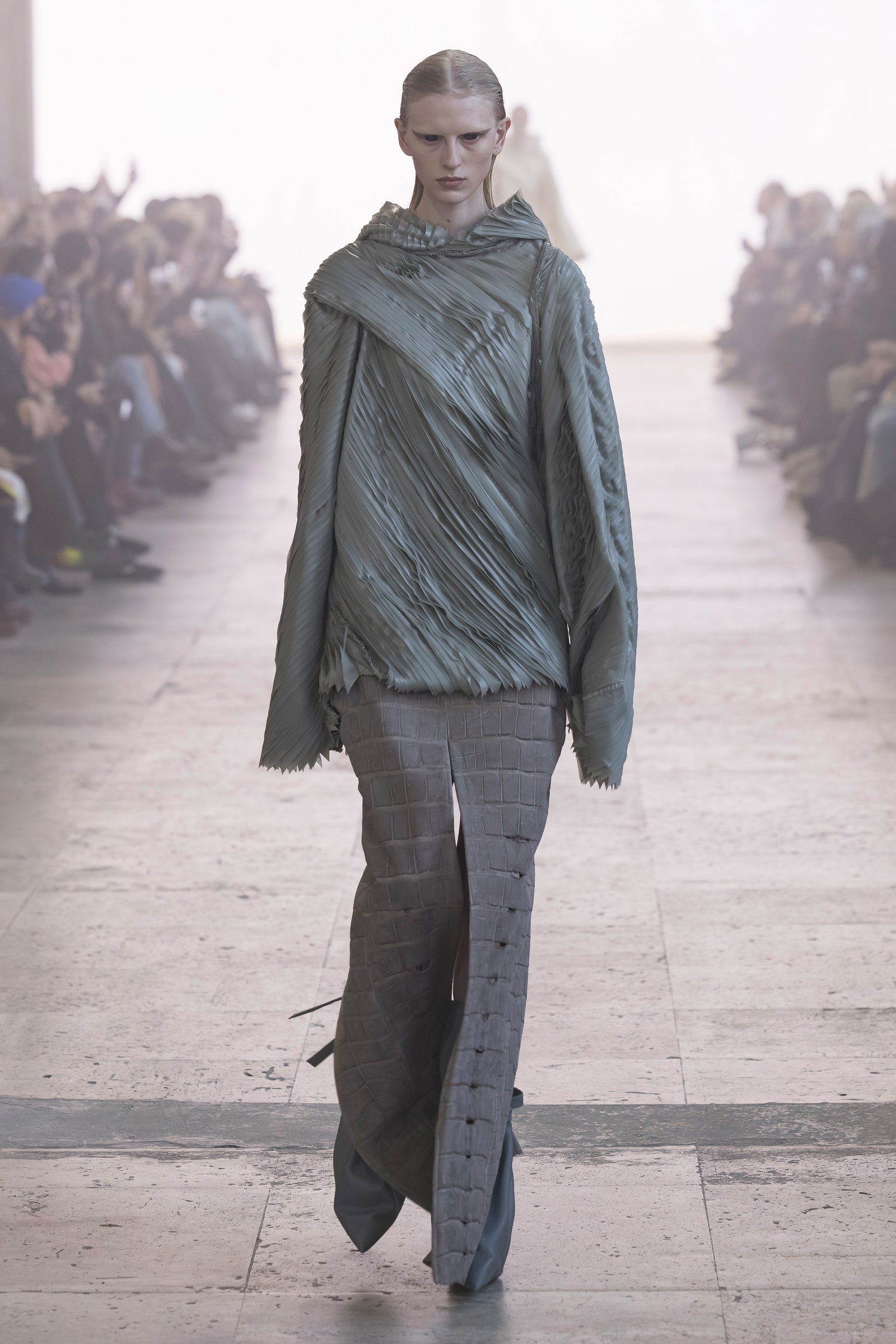 Image may contain people with pants, standing walking adult fashion and coat