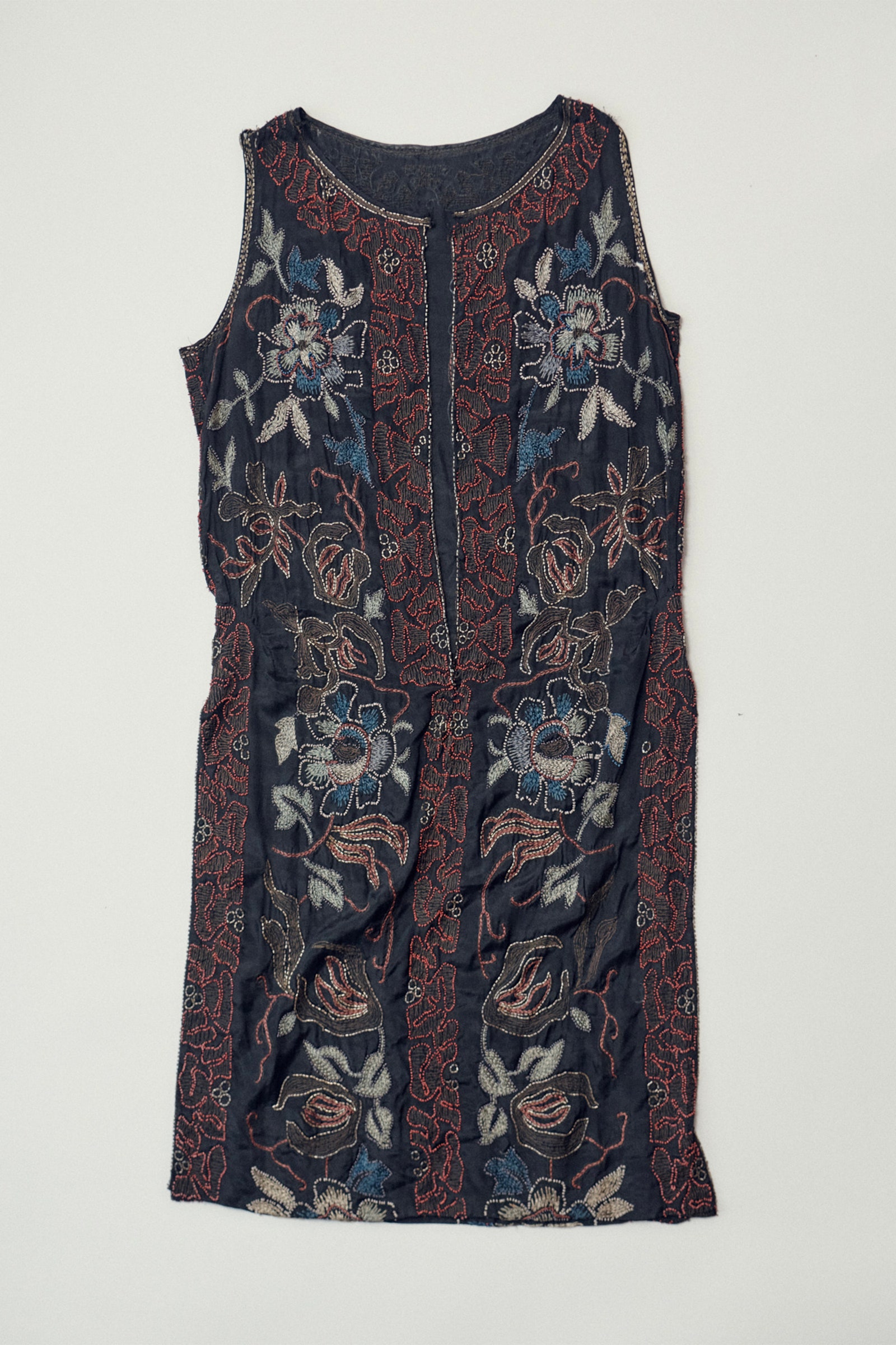 Images may contain clothing vest top dress and pattern