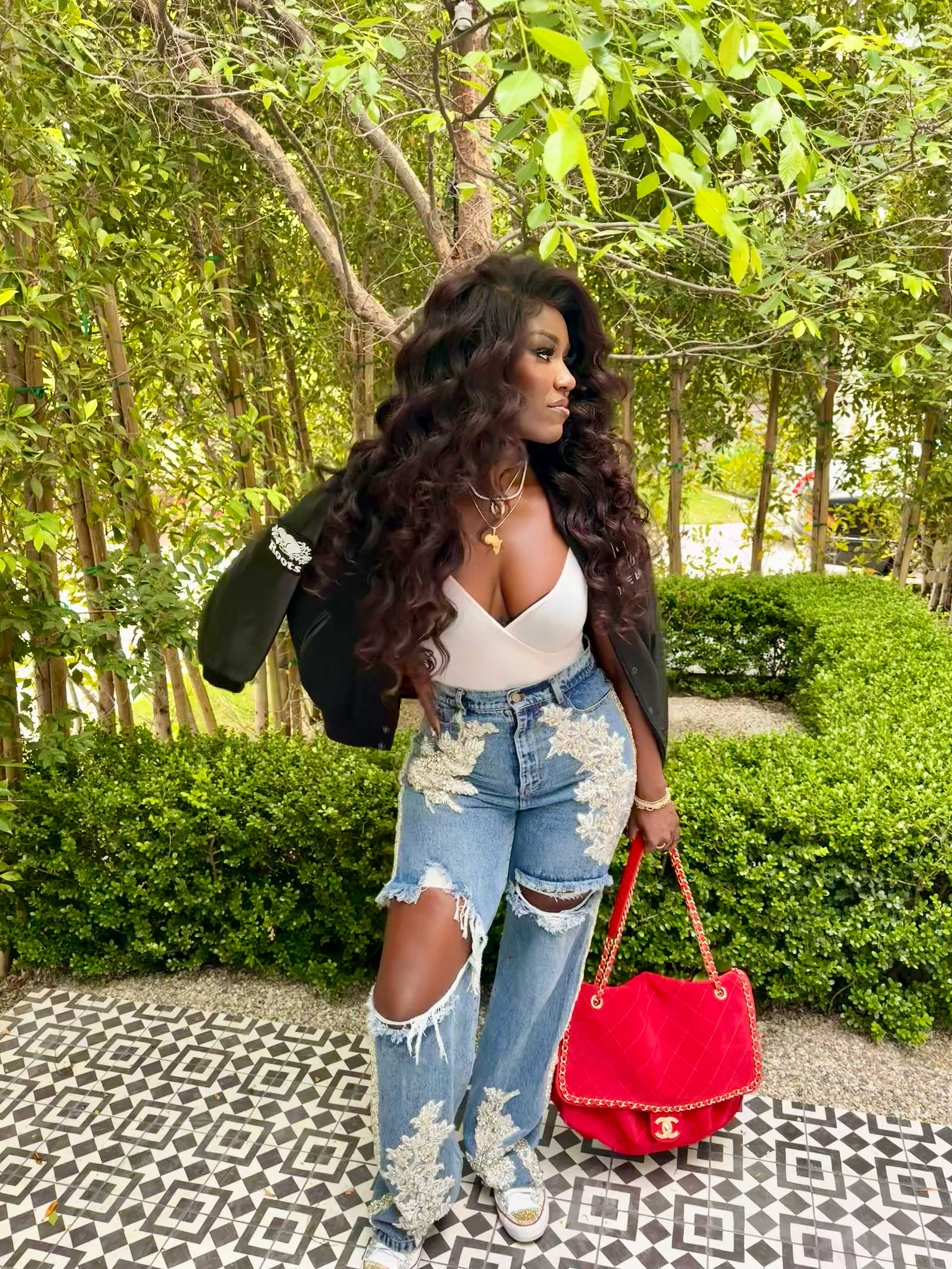 Image may contain hair curl accessories bag tote bag teen jewelry and necklace