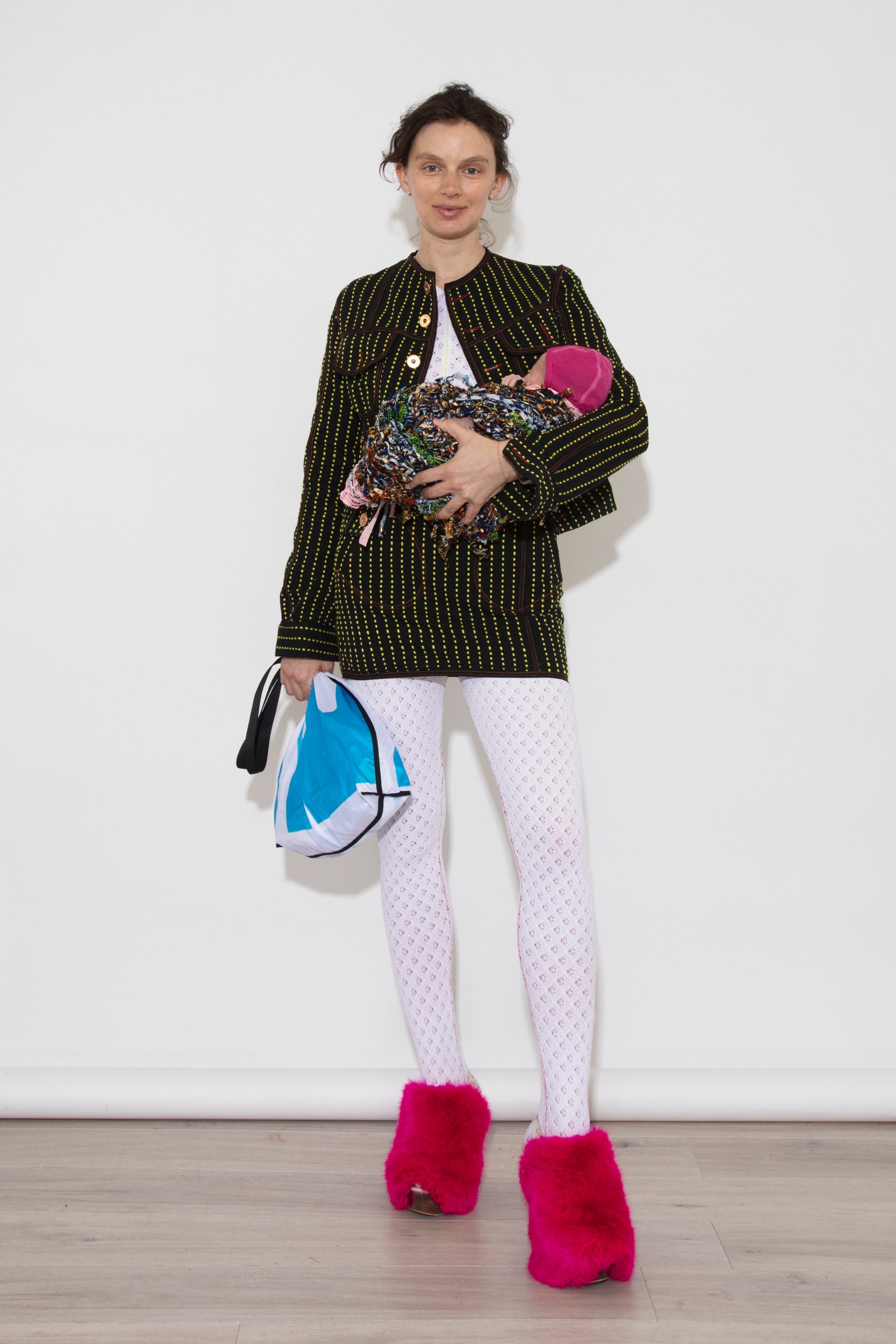 Image may contain Adult Person Blazer Clothing Coat Jacket Accessories Bag Handbag Hat Footwear Shoe and Hosiery