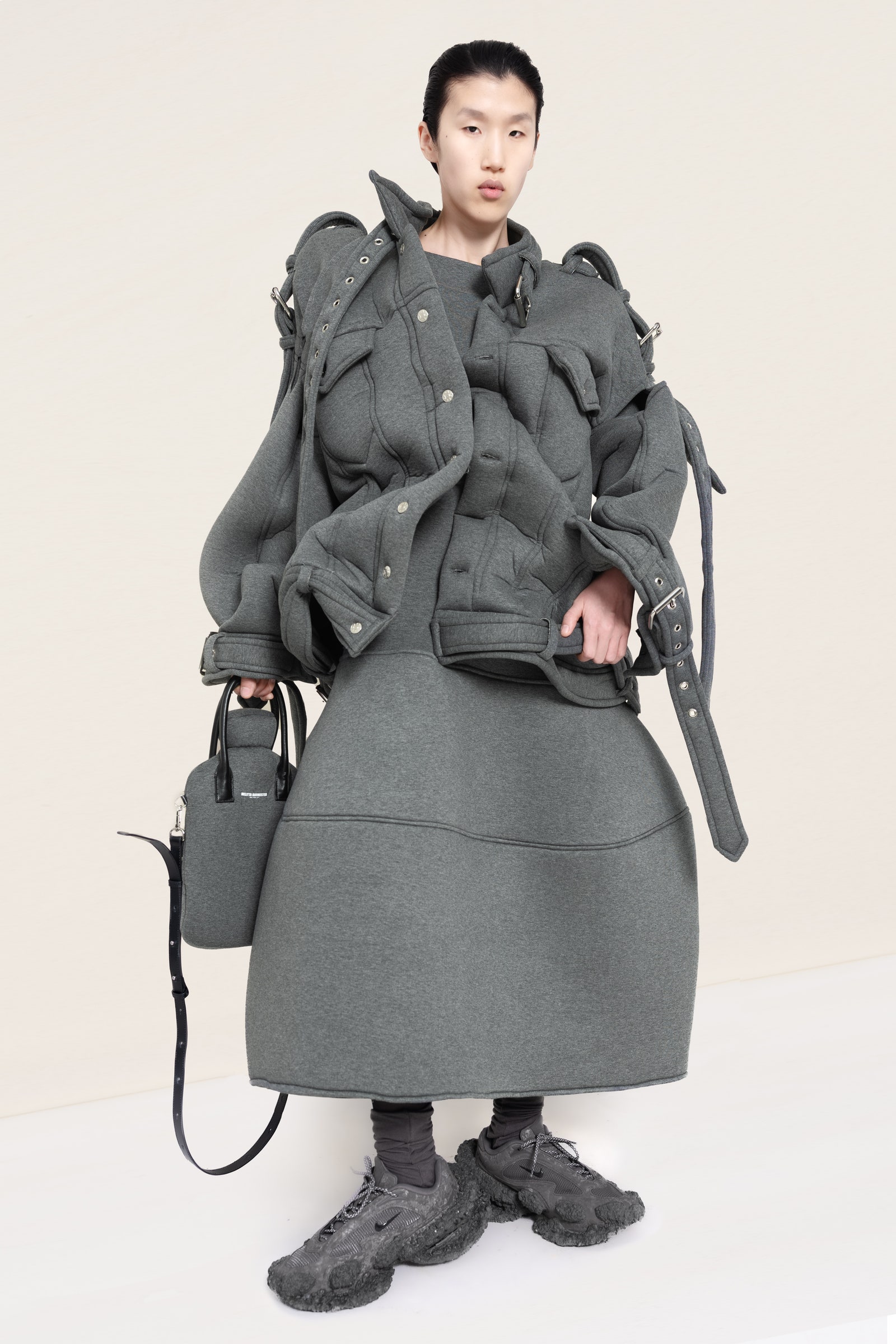 Image may contain Clothing Coat Overcoat Adult Person Accessories Bag and Handbag