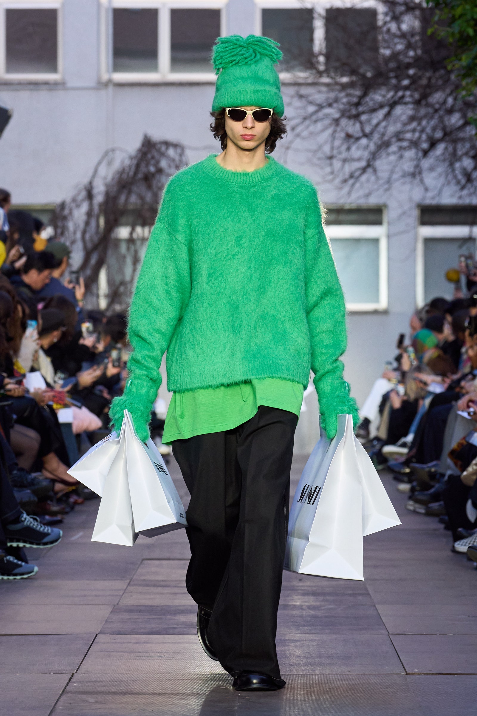 Image may contain Person Accessories Glasses Adult Bag Clothing Knitwear Sweater Footwear Shoe Pants and Handbag