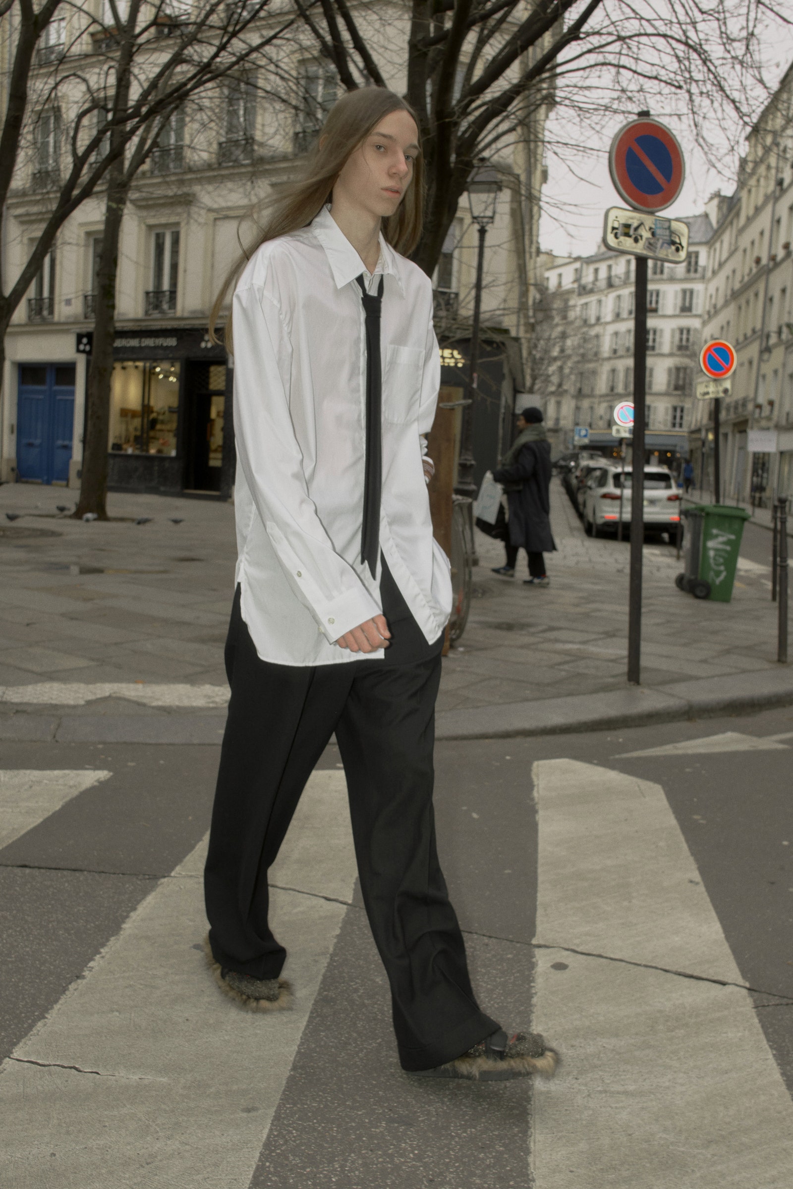 Image may contain Clothing Shirt Pants Road Tarmac Pedestrian Person Accessories Formal Wear Tie and Standing