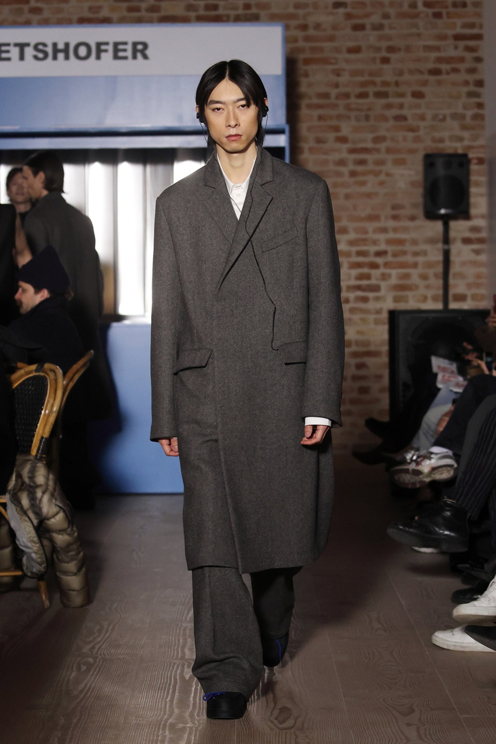 Image may contain Wataru Hatano Clothing Coat Electronics Speaker Person Formal Wear Suit Footwear Shoe and Hat