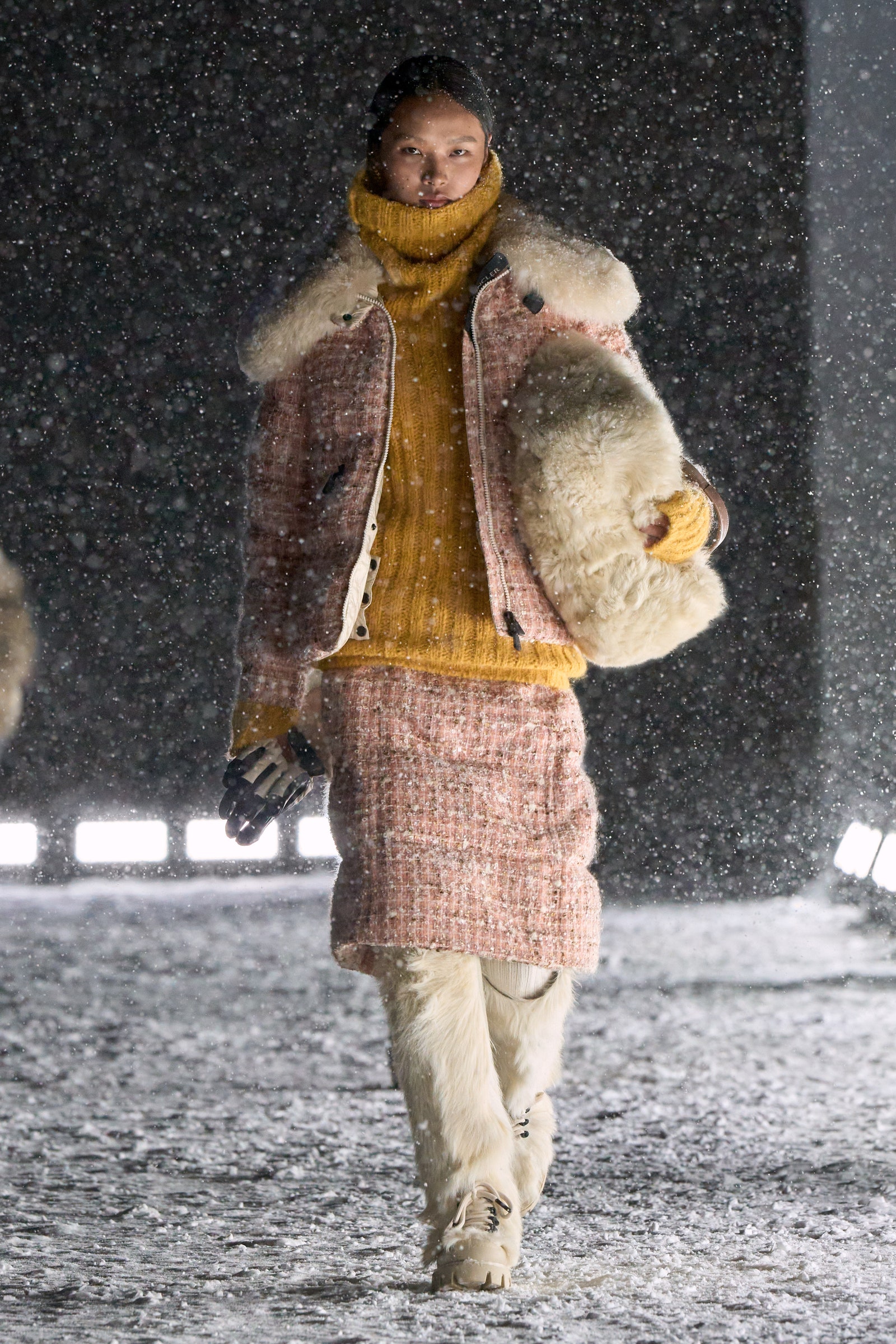 Image may contain Clothing Glove Coat Adult Person Nature Outdoors Winter Jacket Footwear Shoe and Snow