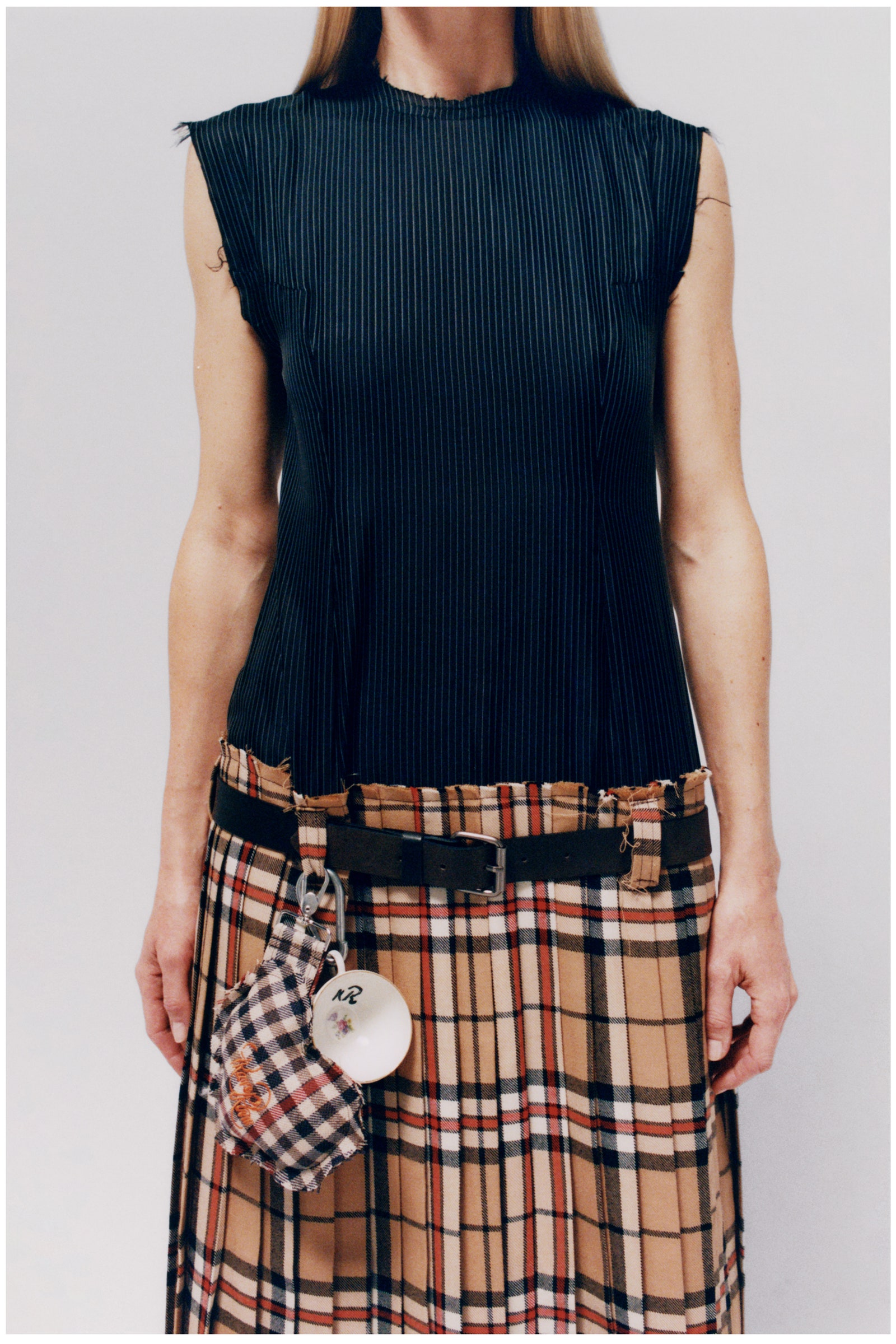 Image may contain Clothing Skirt Adult Person and Tartan