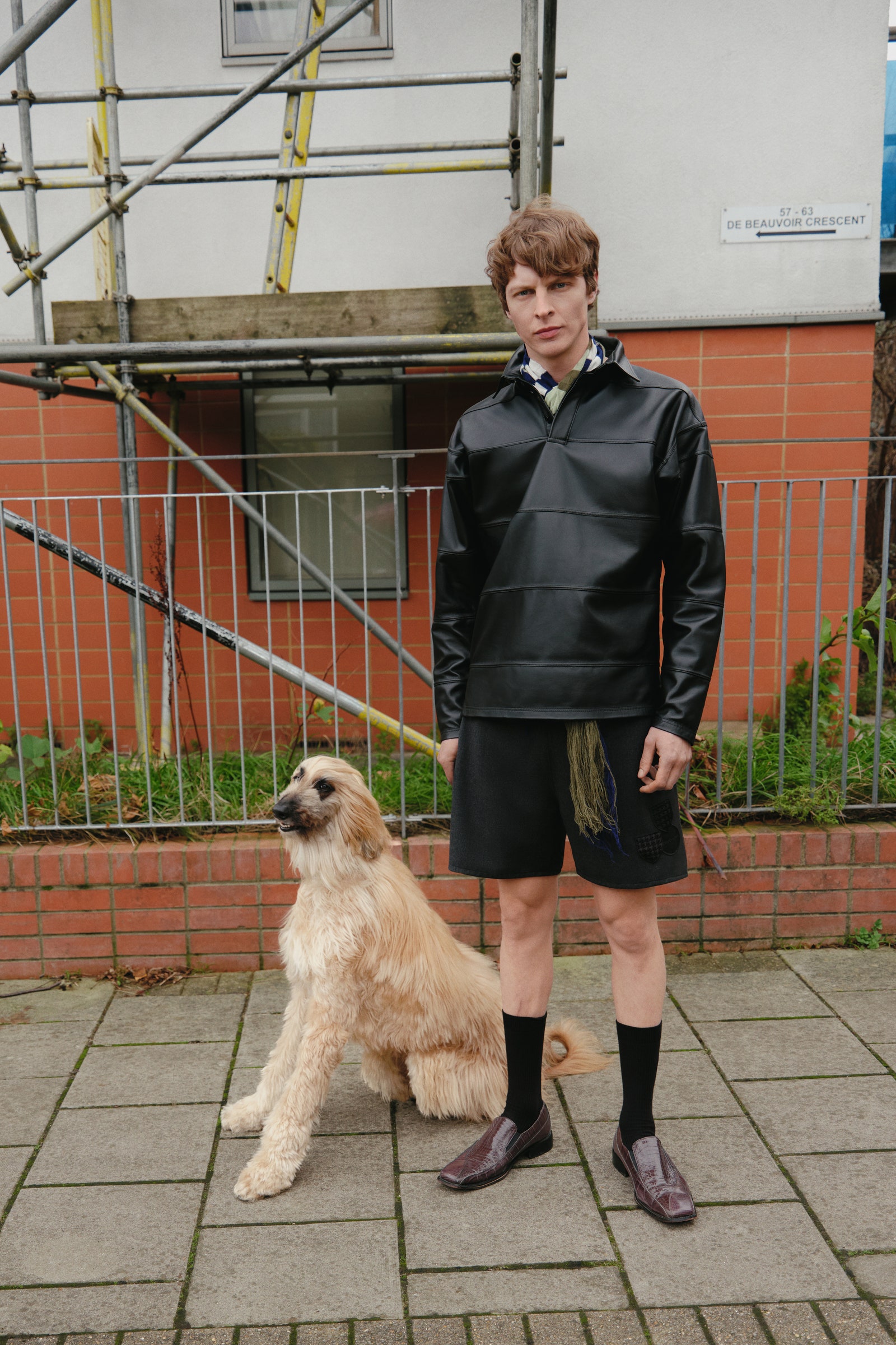 Image may contain Clothing Coat Shorts Face Head Person Photography Portrait Footwear Shoe Jacket Teen and Plant