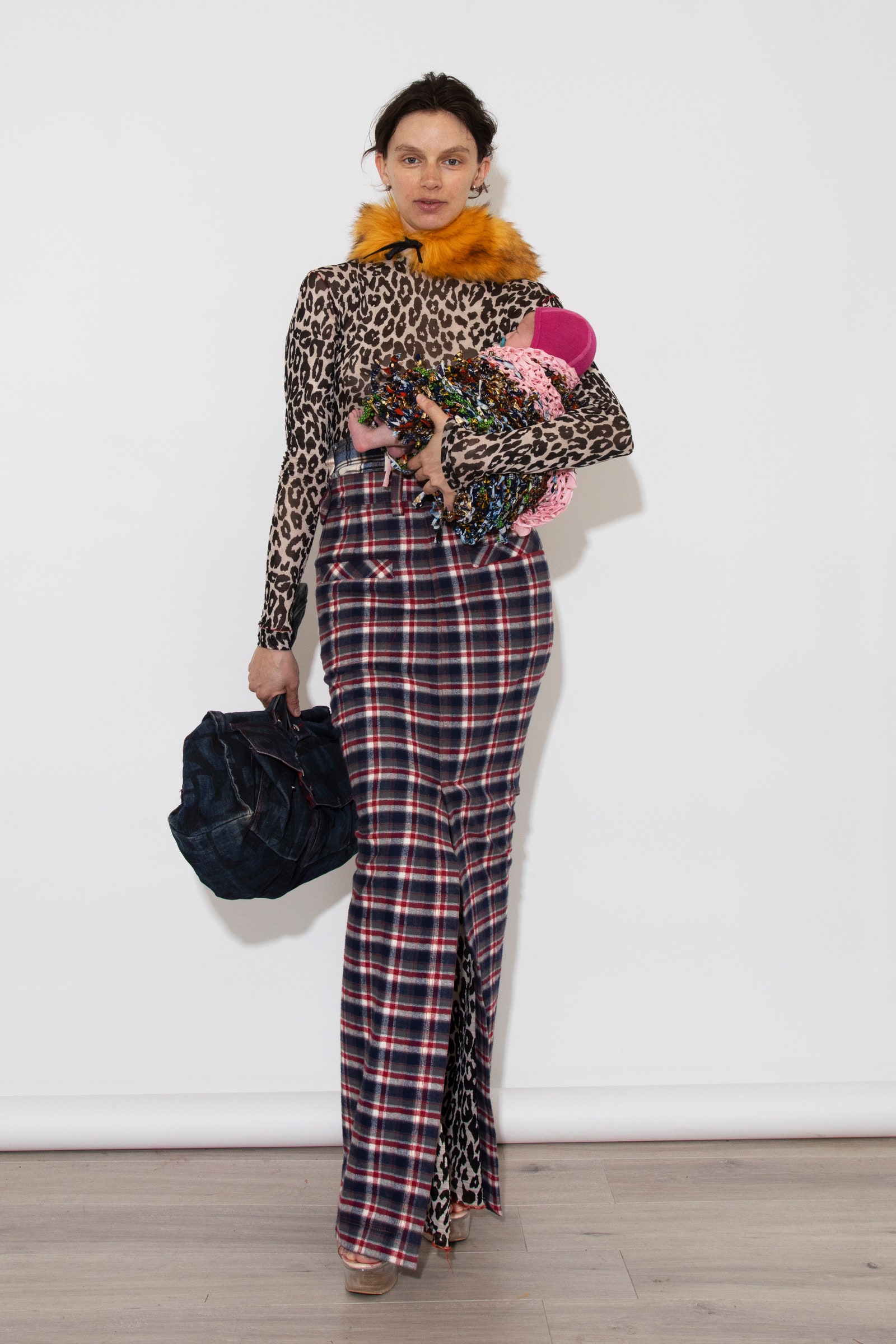 Image may contain Adult Person Clothing Formal Wear Suit Accessories Bag Handbag Pants Dress Footwear and Shoe