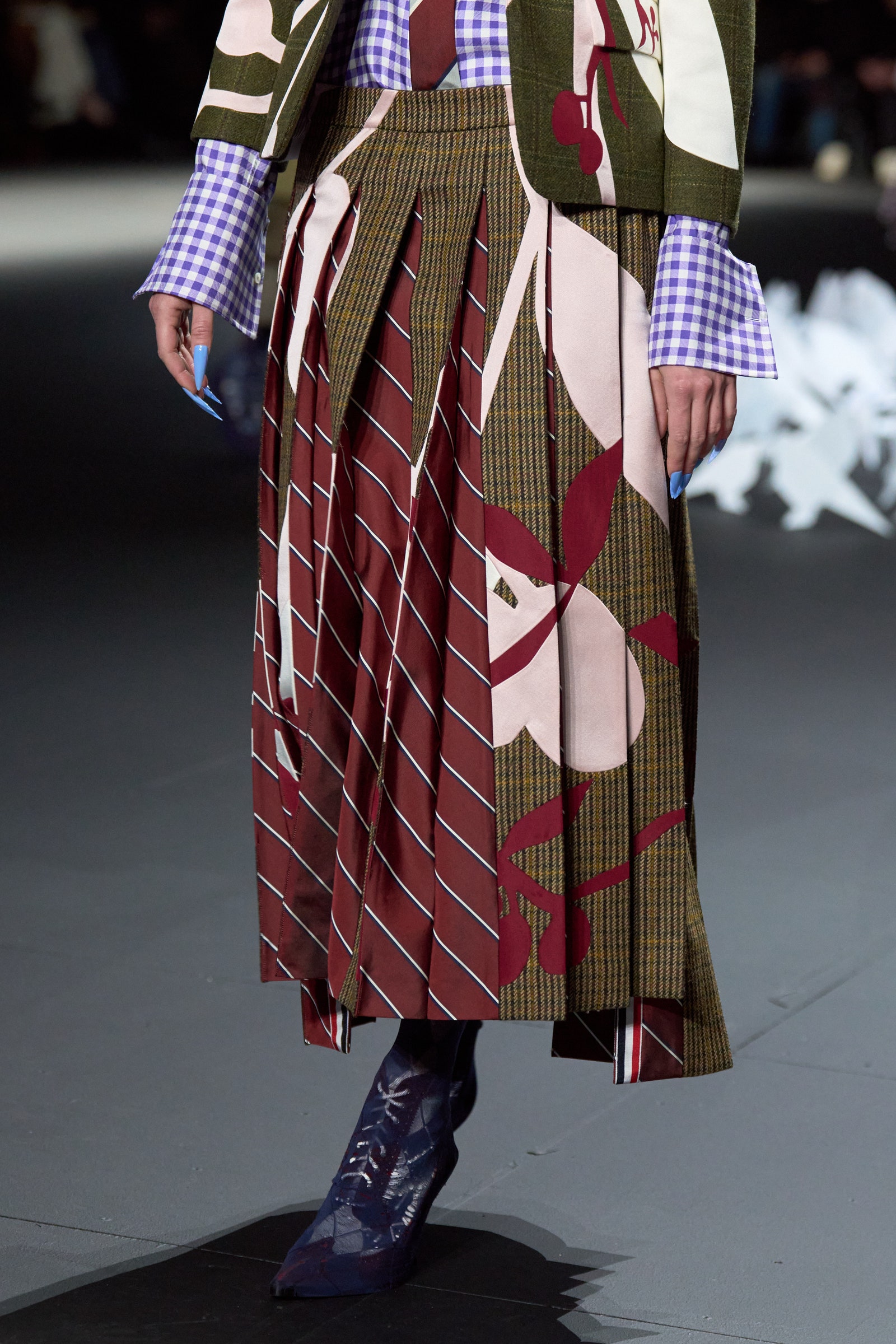 Image may contain Clothing Skirt Fashion Coat Accessories Formal Wear Tie Tartan and Dress