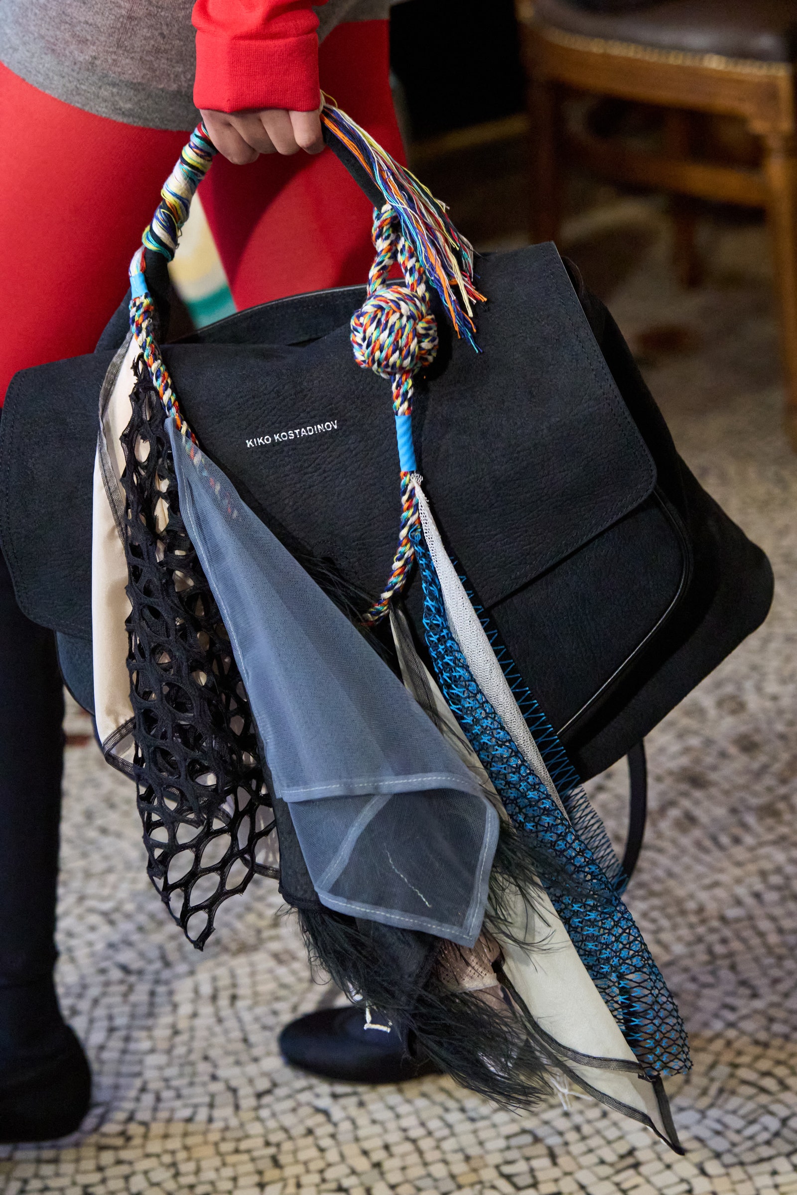 Image may contain Accessories Bag Handbag Purse Chair Furniture Adult Person Clothing Footwear Shoe and Tote Bag