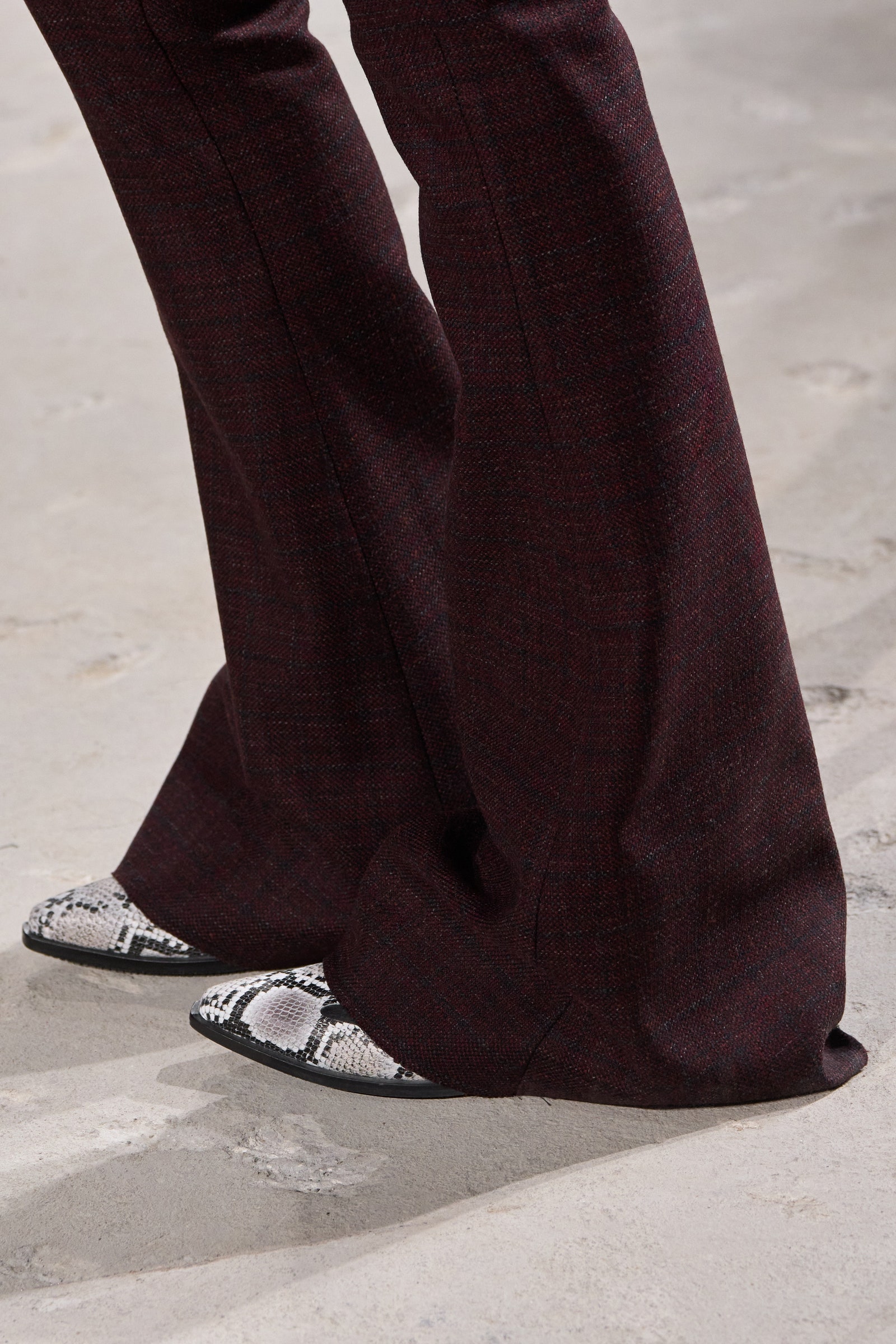 Image may contain Person Walking Clothing Pants Footwear Shoe Sneaker and Sandal