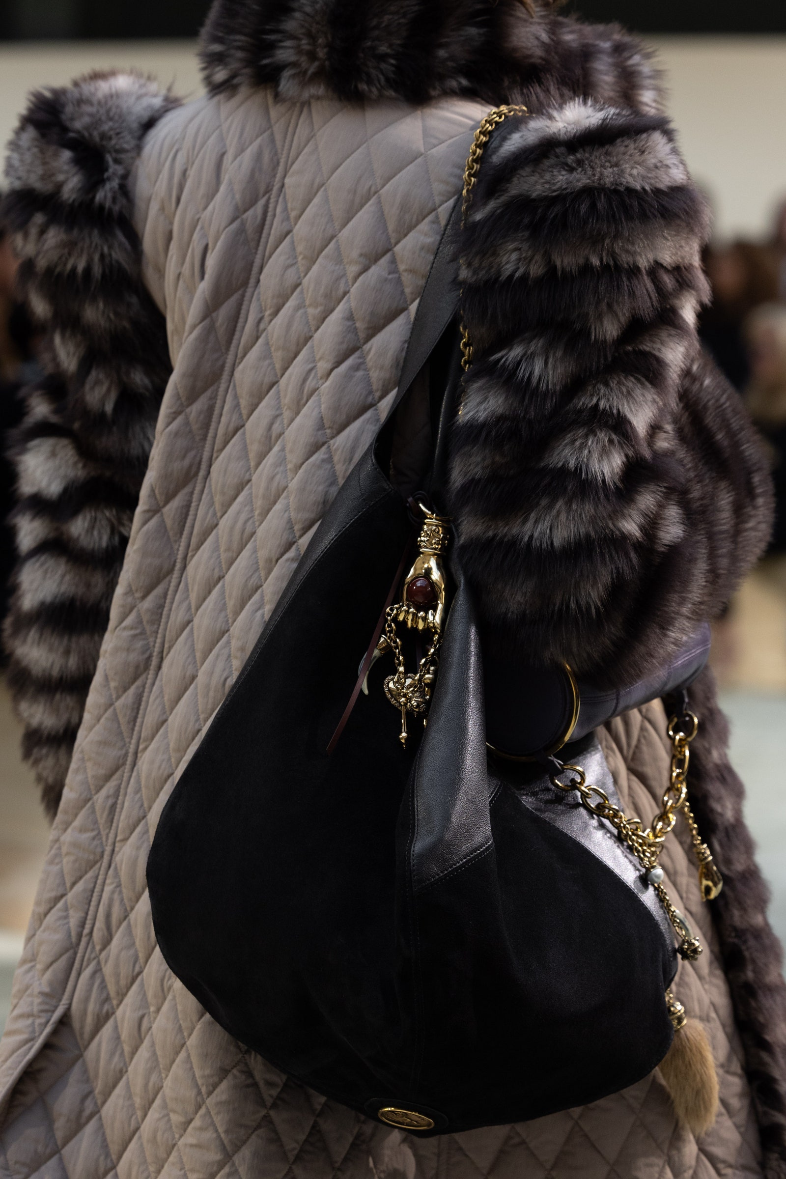 Image may contain Accessories Bag Handbag Purse Clothing Coat Adult Person Jewelry and Necklace
