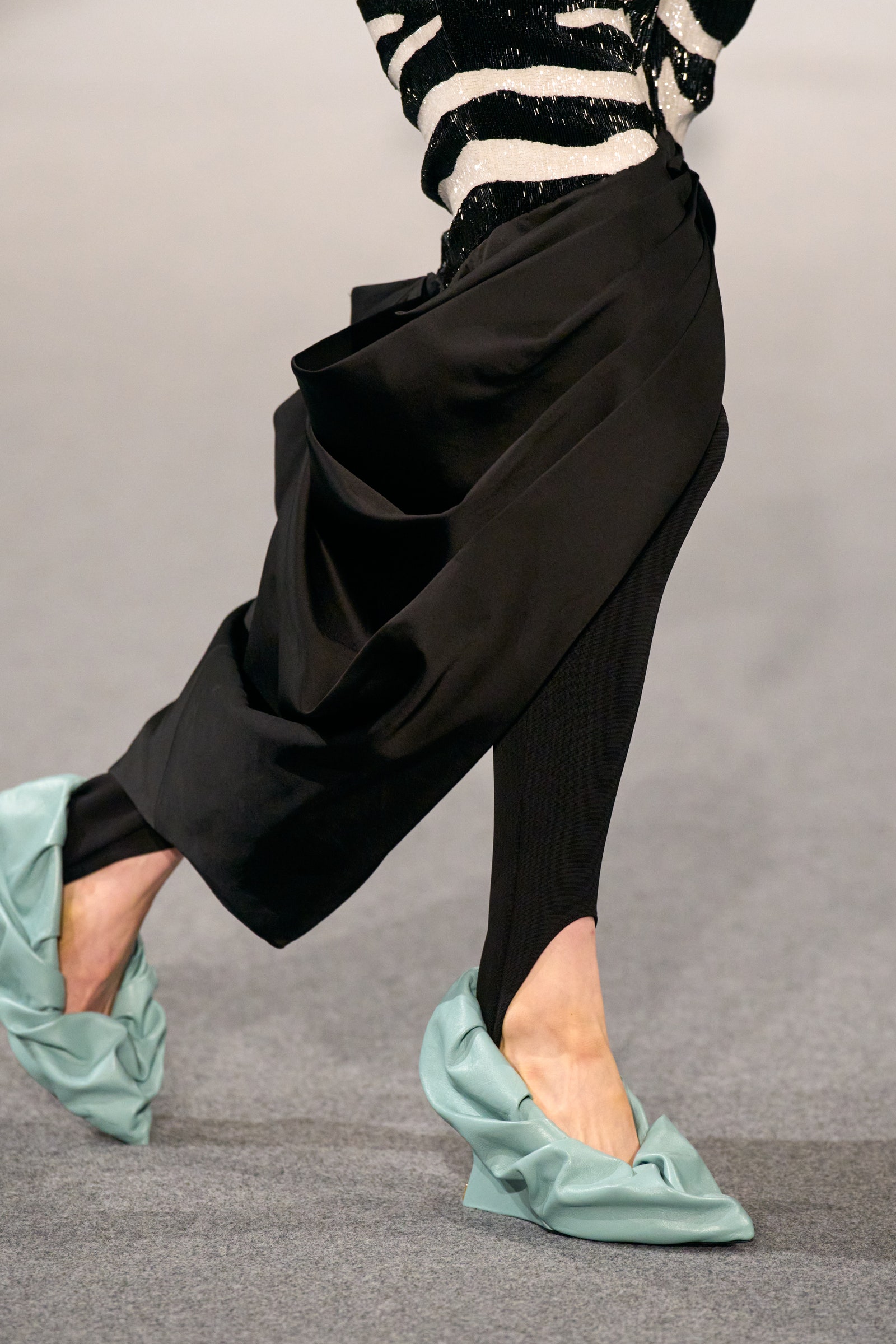 Image may contain Clothing Footwear Shoe High Heel Person Walking Sneaker and Pants