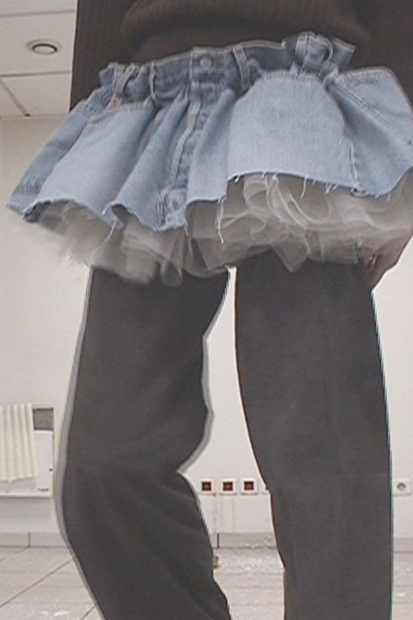 Image may contain Clothing Pants Jeans Skirt and Person