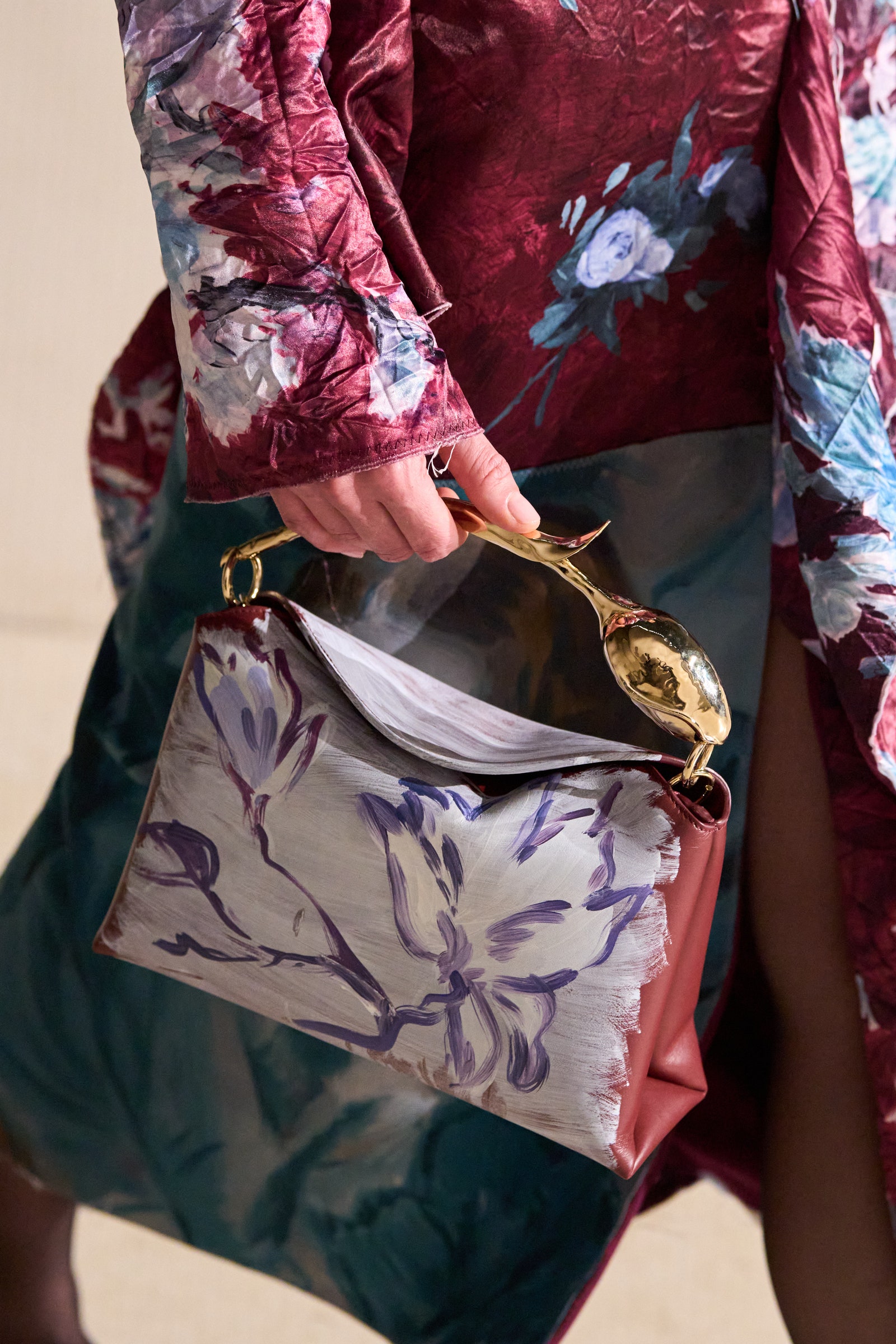Image may contain Clothing Dress Accessories Bag Handbag Fashion Formal Wear Gown Purse Robe Cutlery and Spoon