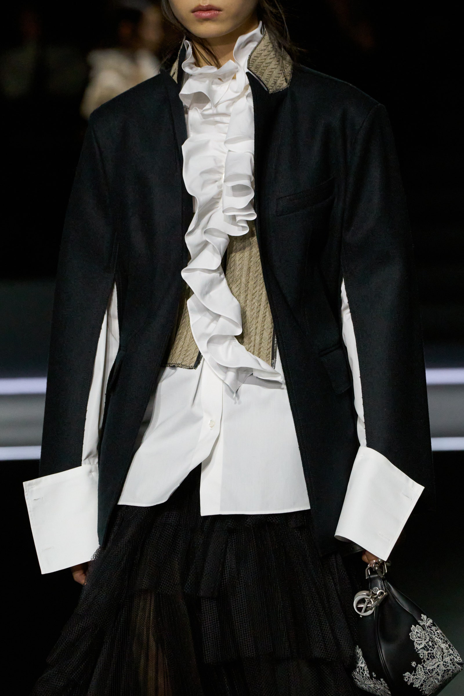 Image may contain Clothing Coat Jacket Blazer Long Sleeve Sleeve Formal Wear Suit Fashion Accessories and Bag
