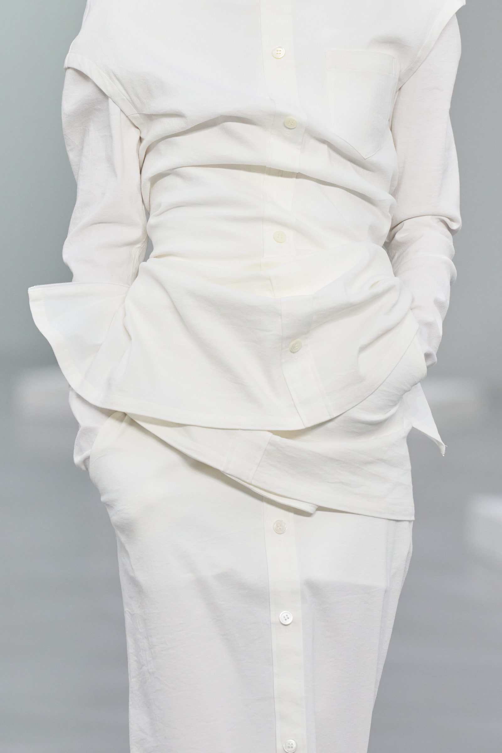 Image may contain Clothing Long Sleeve Sleeve Blouse Shirt Pants Adult Person Formal Wear and Stain