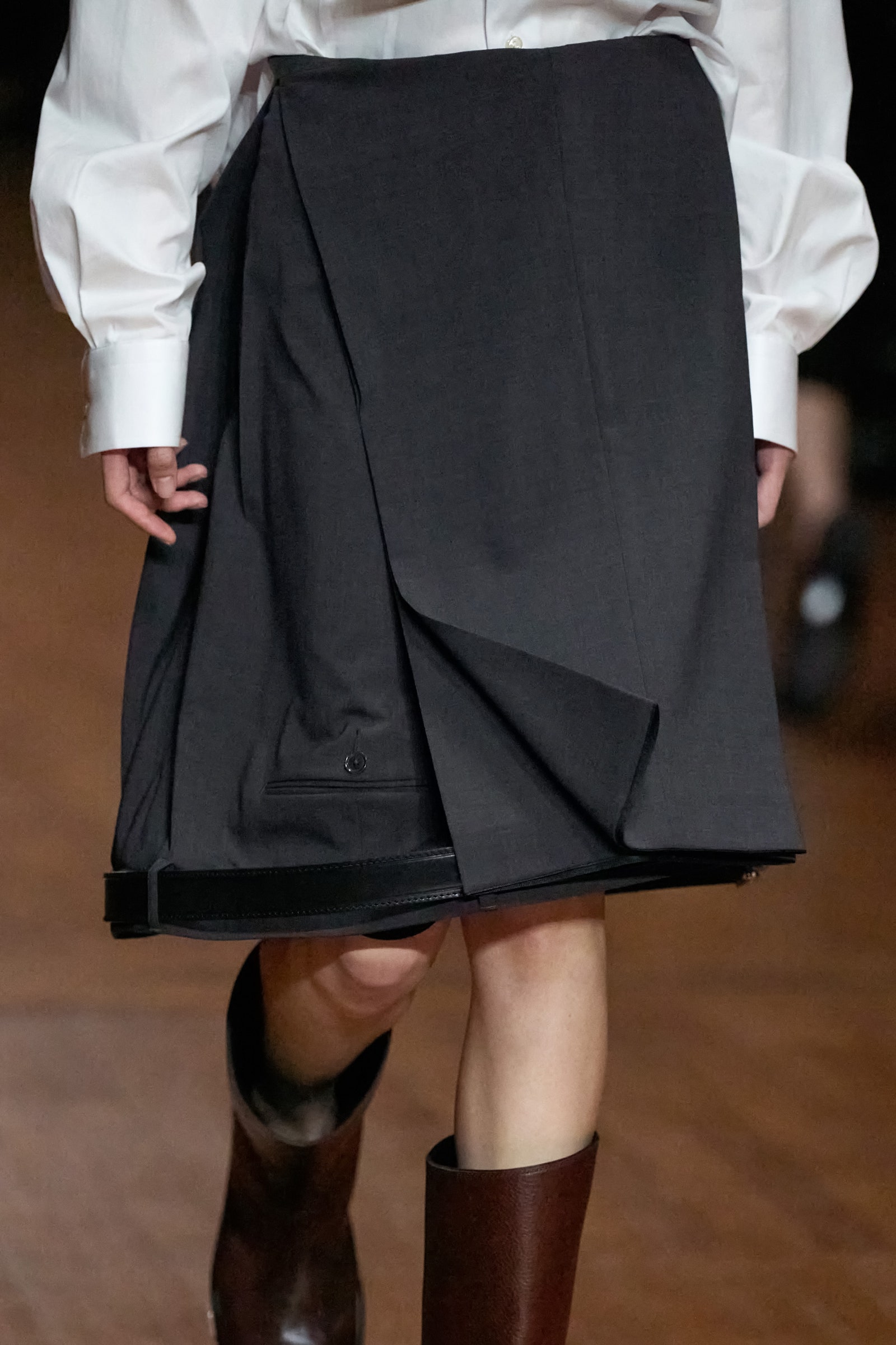 Image may contain Clothing Skirt Coat and Person