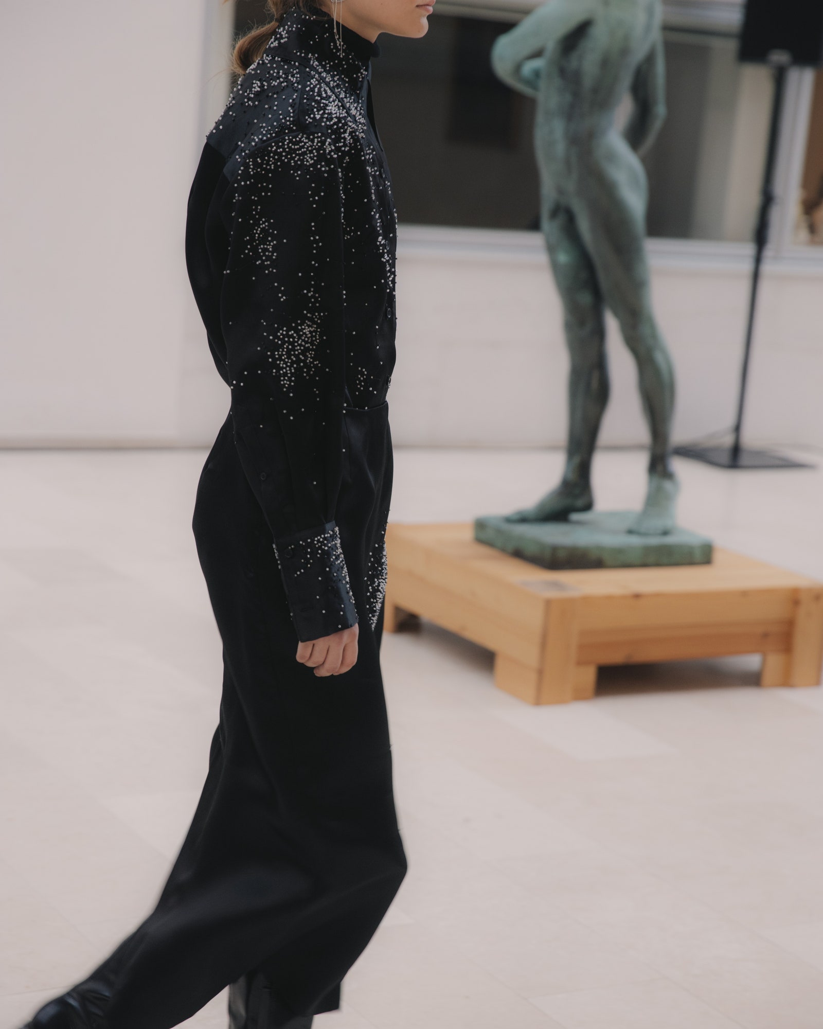 Image may contain Clothing Long Sleeve Sleeve Formal Wear Suit Coat Adult Person Pants Footwear Shoe and Dress