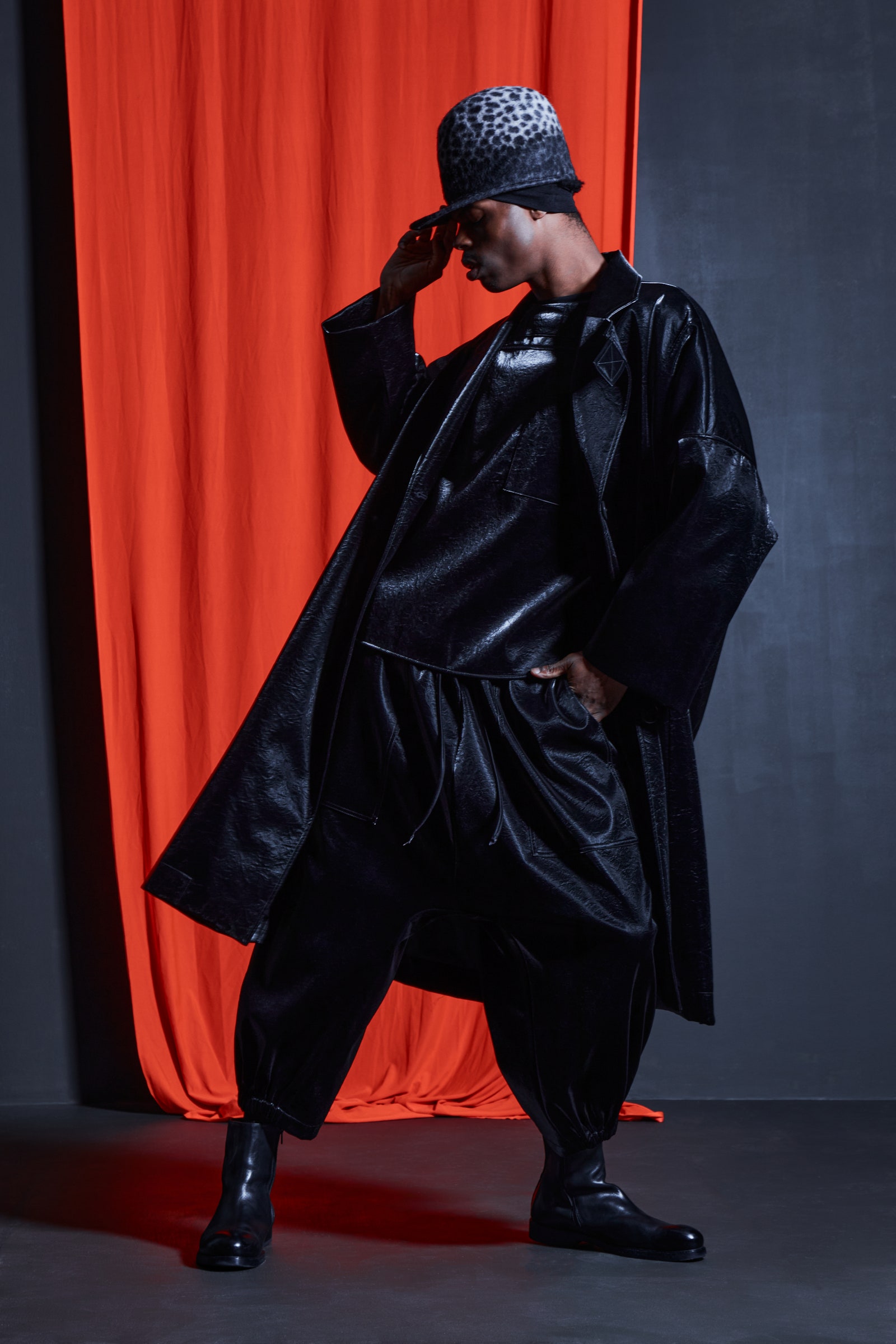 Image may contain Clothing Coat Adult Person Hat Performer Solo Performance Footwear Shoe and Fashion