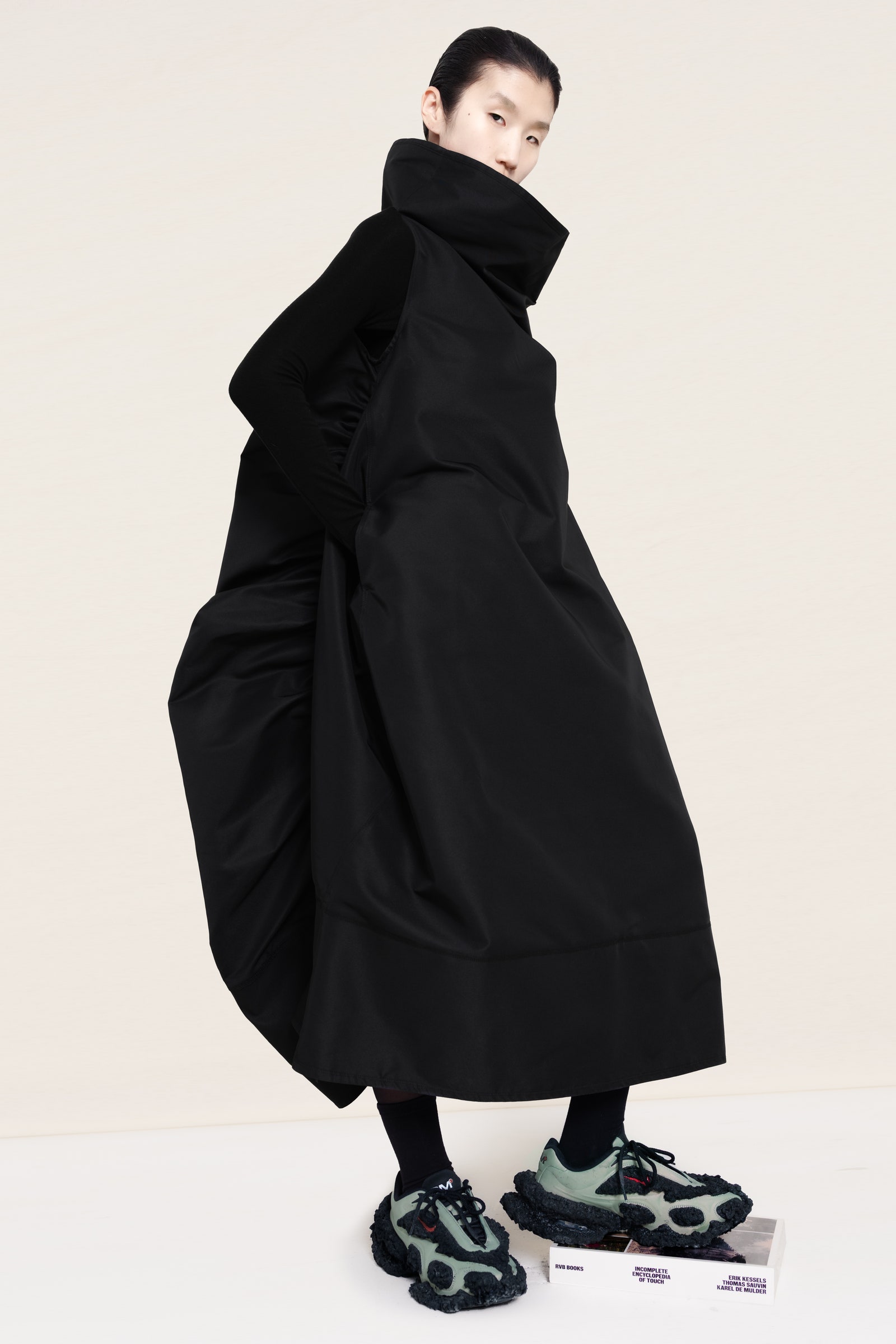 Image may contain Clothing Coat Footwear Shoe Fashion Cape and Overcoat