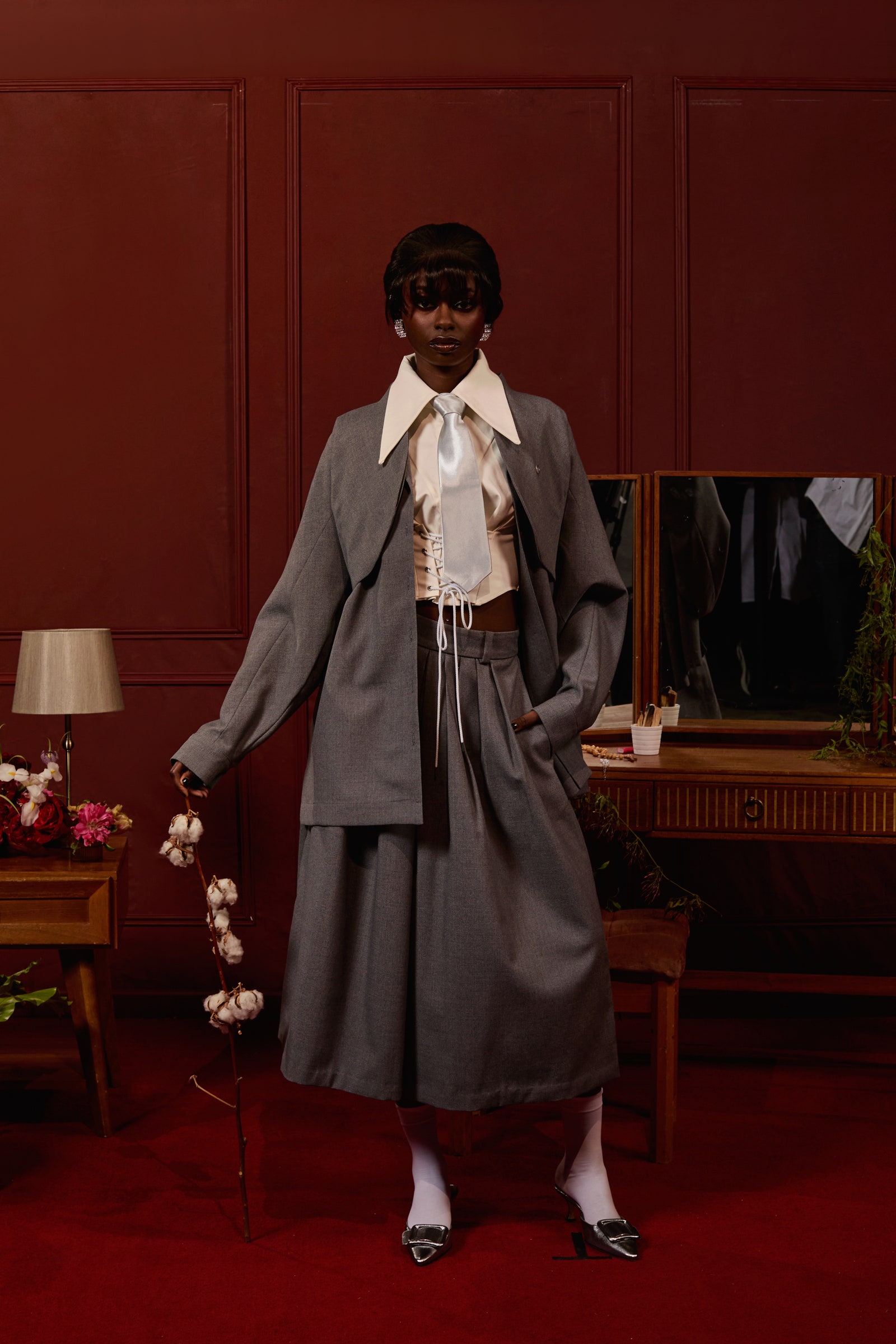 Image may contain Accessories Formal Wear Tie Person Adult Clothing Footwear High Heel Shoe Cup Coat and Desk