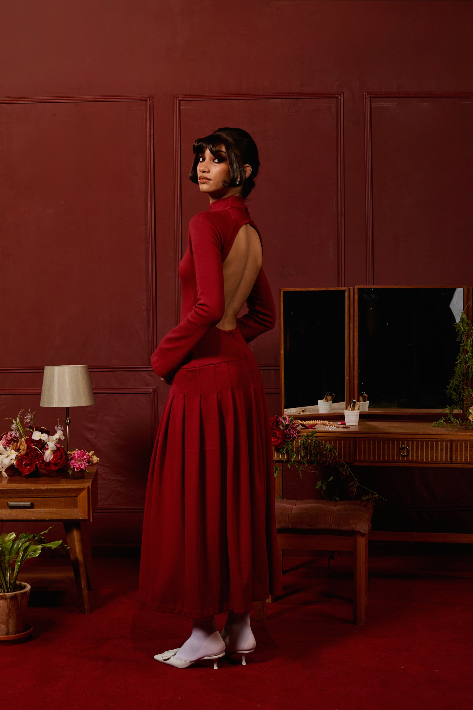 Image may contain Clothing Dress Adult Person Evening Dress Formal Wear Fashion Plant Cup Desk and Furniture