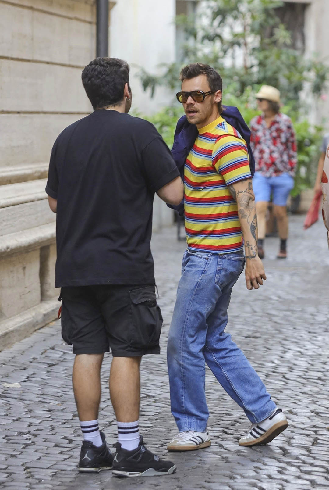 Images may contain clothing shoes shoes accessories glasses pants pants adult hat pedestrian shorts and bags
