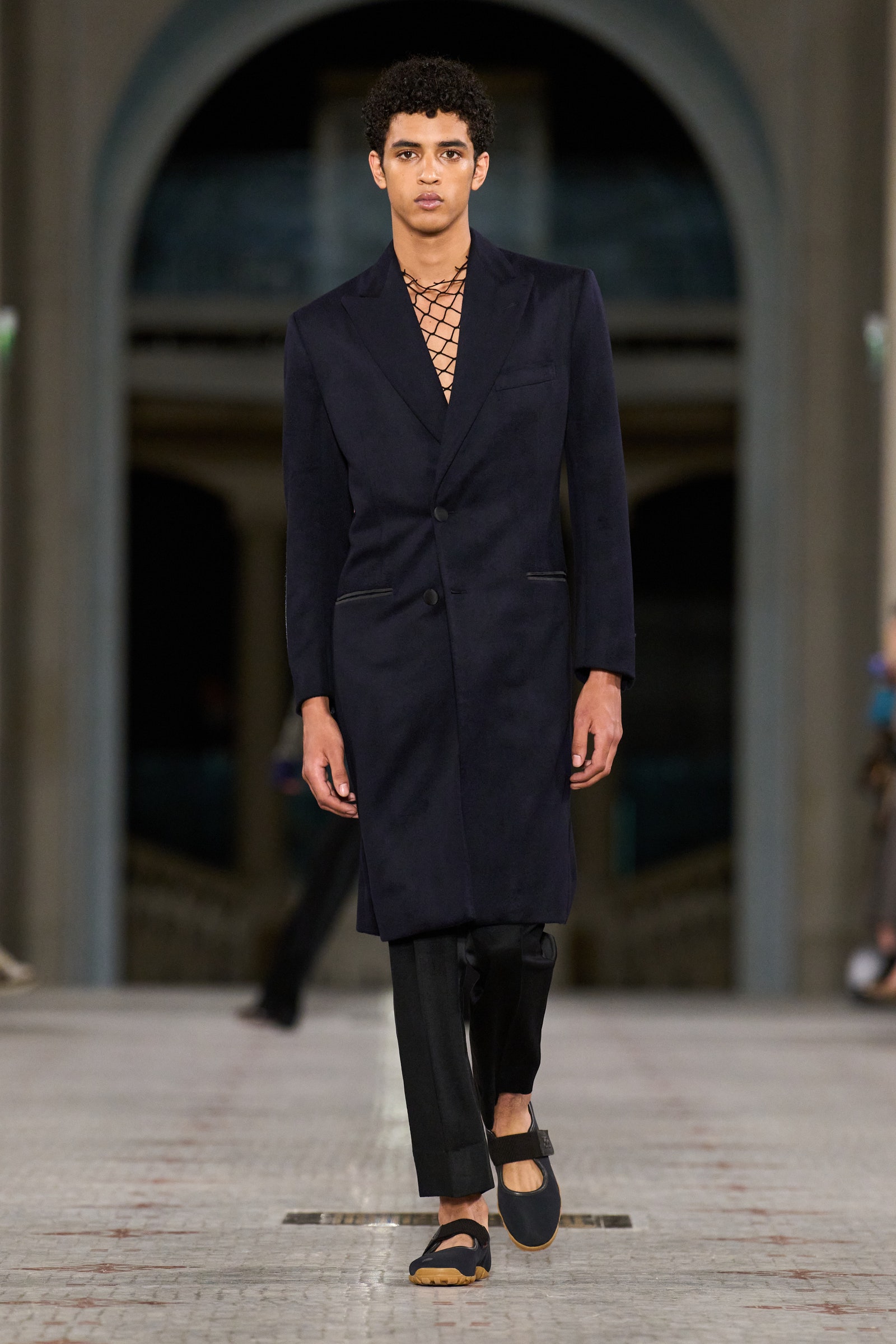 Images may contain clothing formal wear suit adult accessories jewelry necklace blazer and jacket