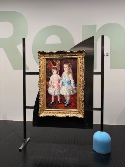 View of Renoir painting on metal easel with other elements. 