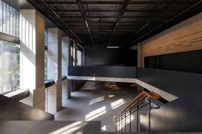 The reception area can be seen from the stairs with a lobby and balcony. 