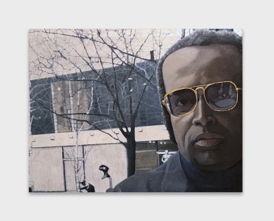 A painting of a man wearing glasses in front of him.