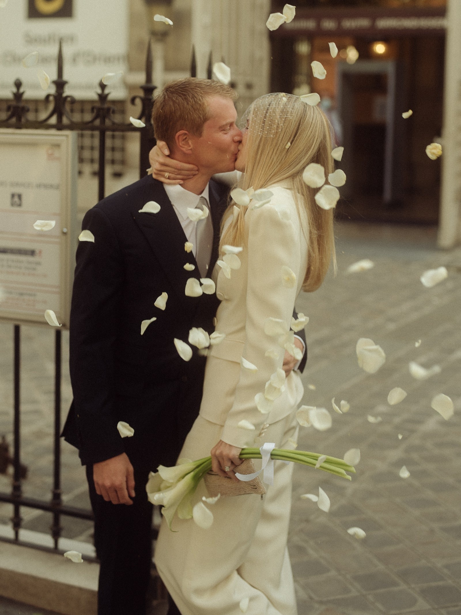 Images may contain blazer clothing blazer face head photography portrait formal wear suit and flowers