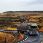 A truck traveling through the pastoral countryside.