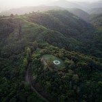 Aerial view of lush Thai landscape. The center is a circular land art installation.