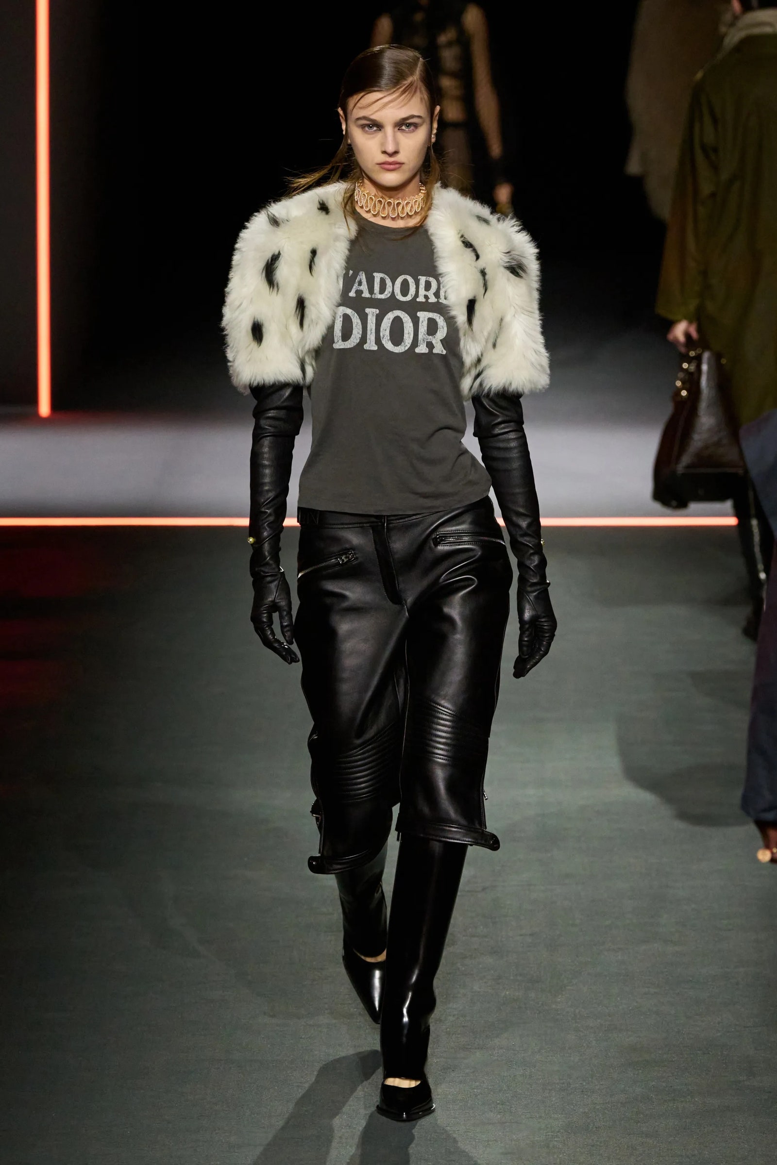 Images may contain clothes long sleeves stylish gloves adult accessories handbags and pants