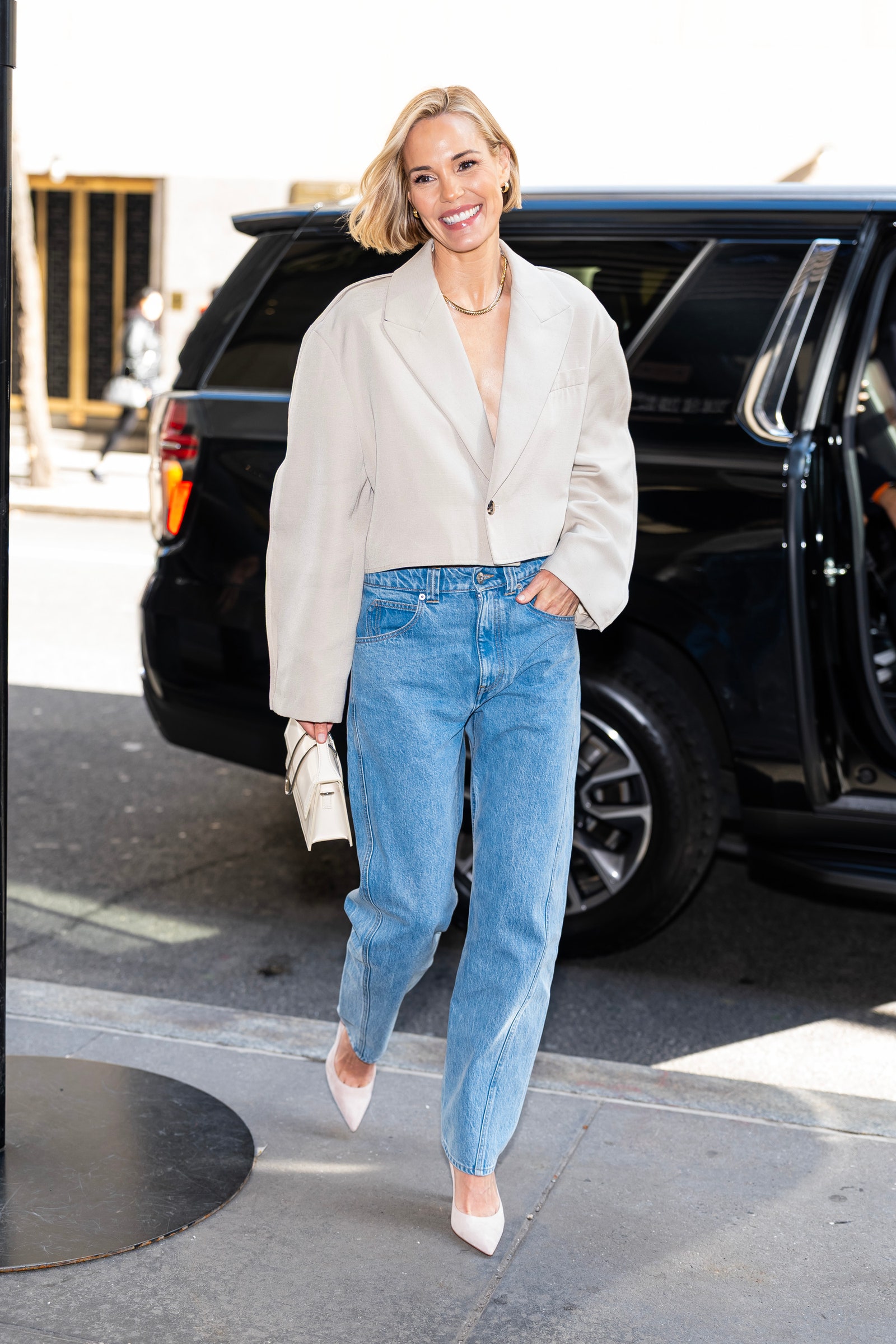 Images may contain Leslie Bibb clothing pants jeans accessories jewelry necklace adults and cars
