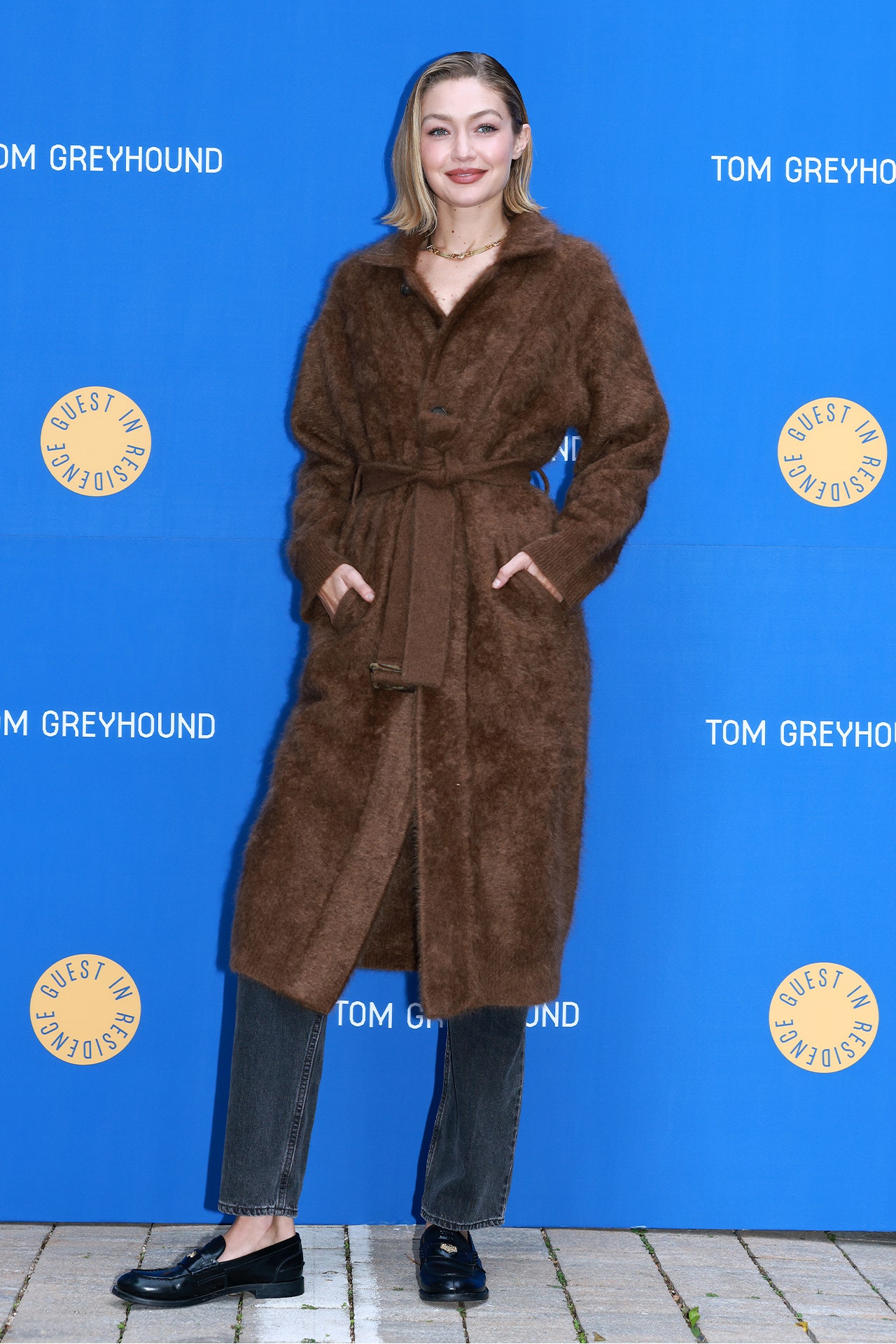 Images may contain Gigi Hadid clothing stylish adult accessories jewelry necklace coat and shoes