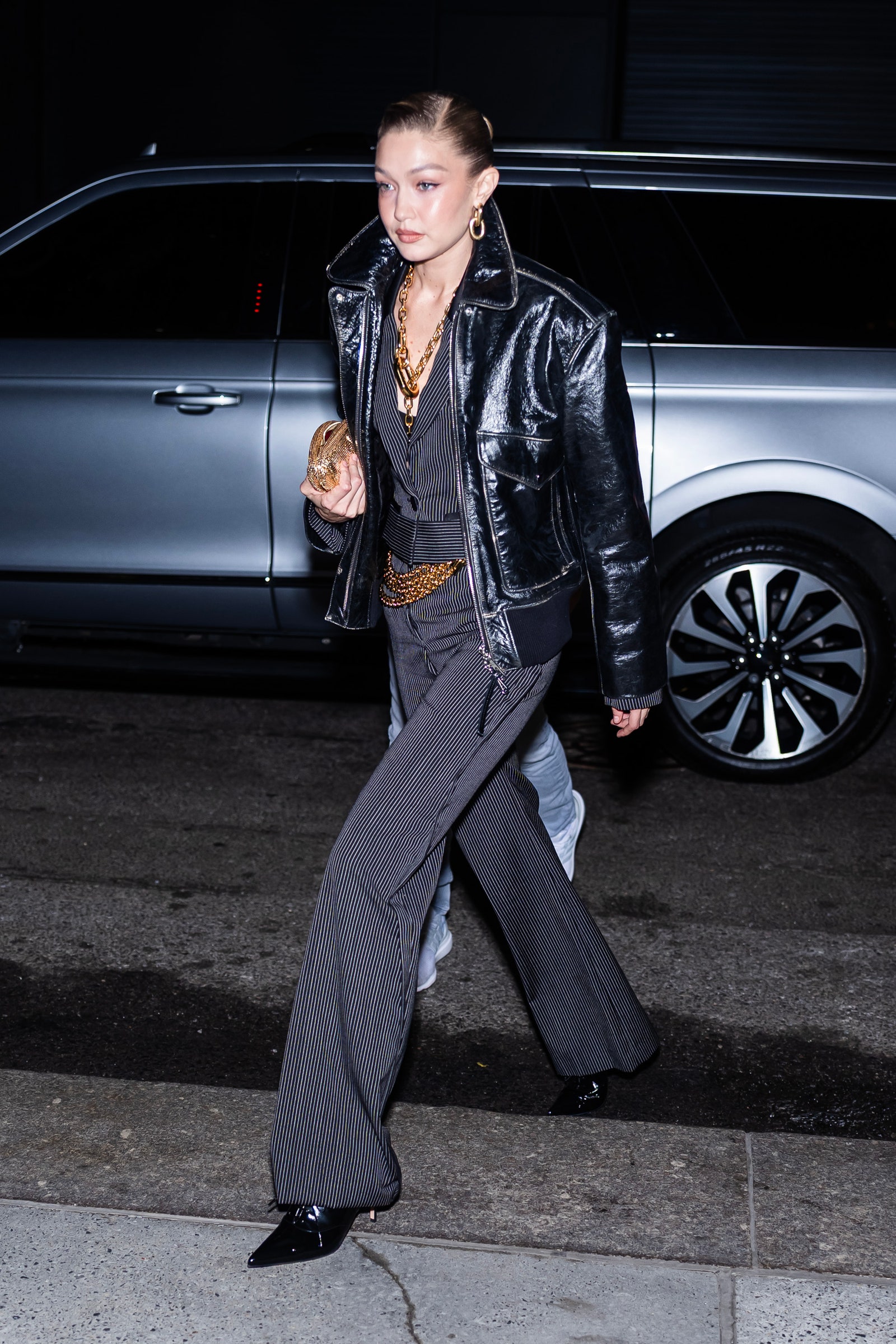 Images may contain accessories and bags for Gigi Hadid clothing, jacket, pants, shoes, high heels