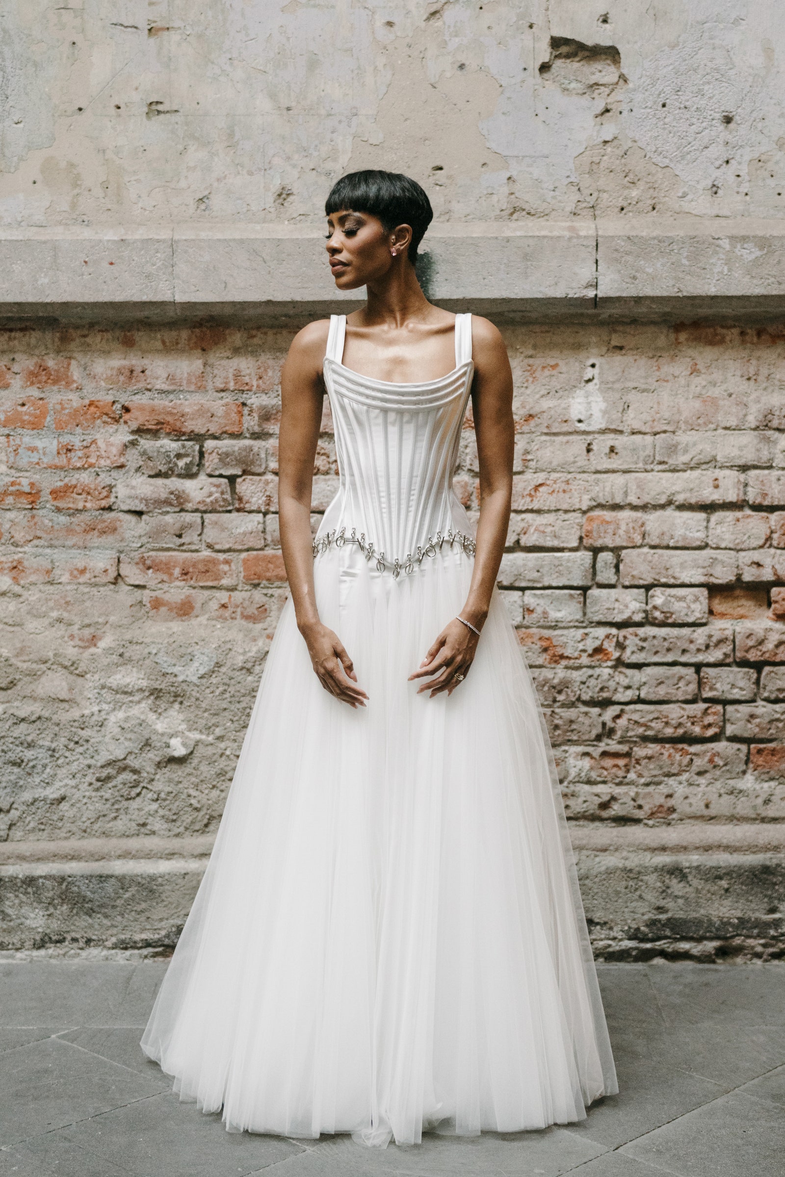 Images may contain clothing stylish formal wear dress wedding dress sleeves and stand