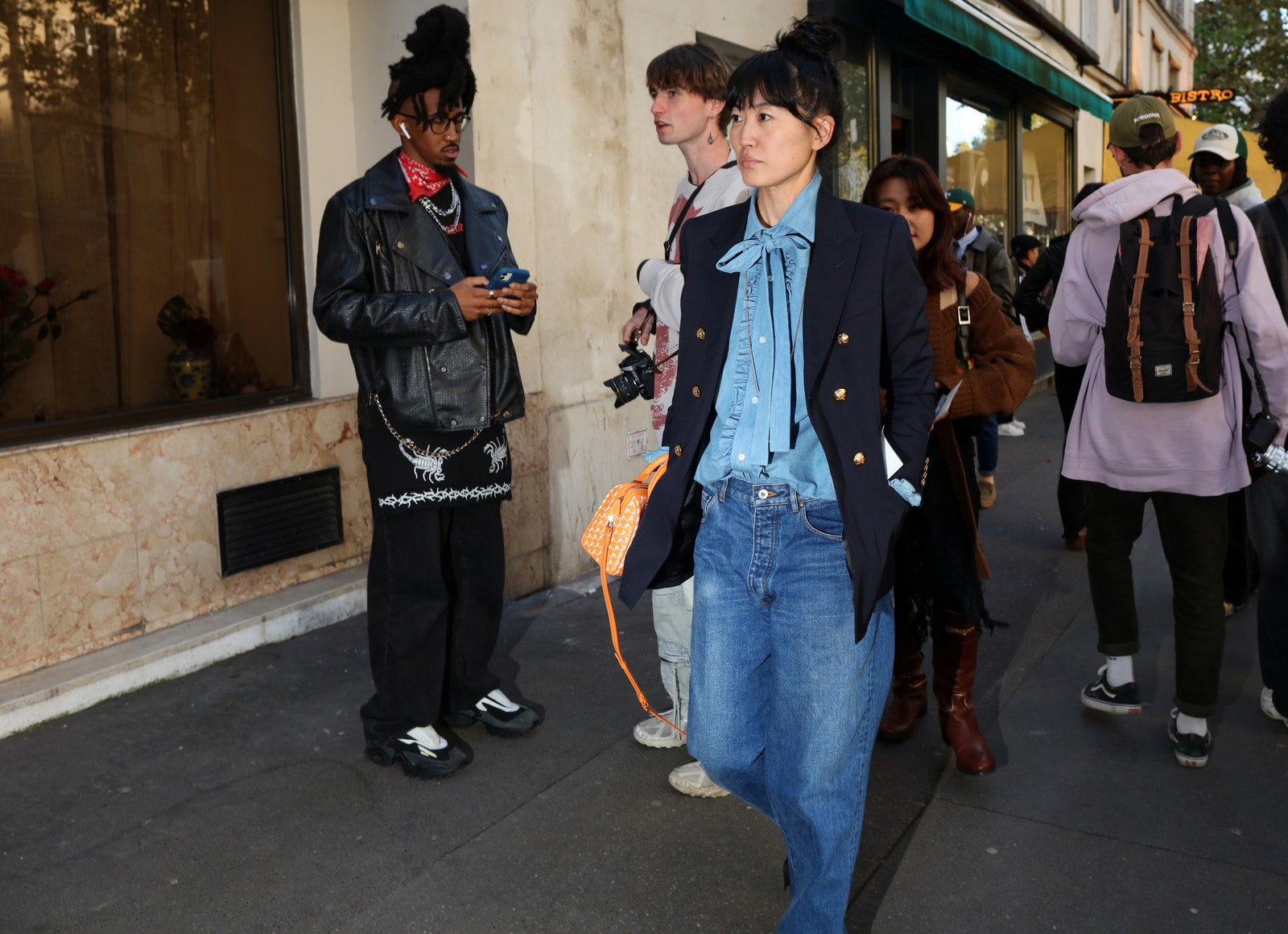 Images may contain clothes pants adult hat jeans shoes shoes shoes cameras and electronic devices
