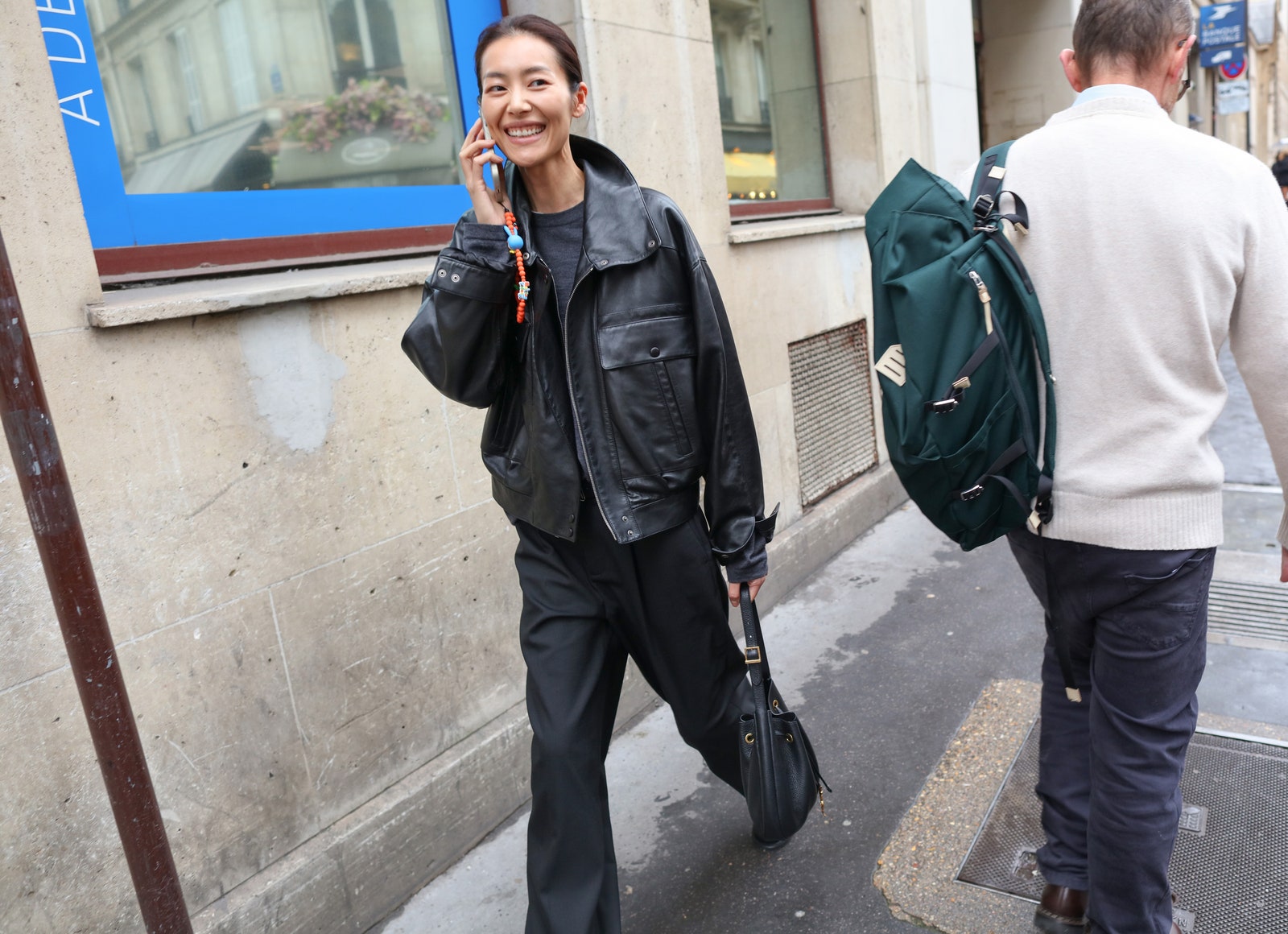 Images may contain Liu Wen clothing jacket adult accessories bag handbag handbag handbag walking backpack and footwear