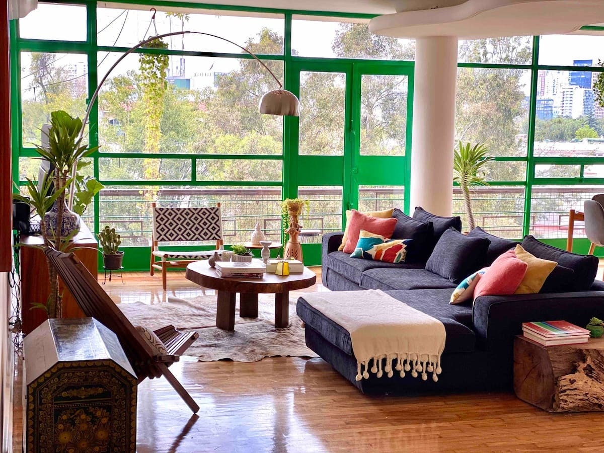 Images may contain home decoration sofa furniture chair plant carpet building in indoor living room and room