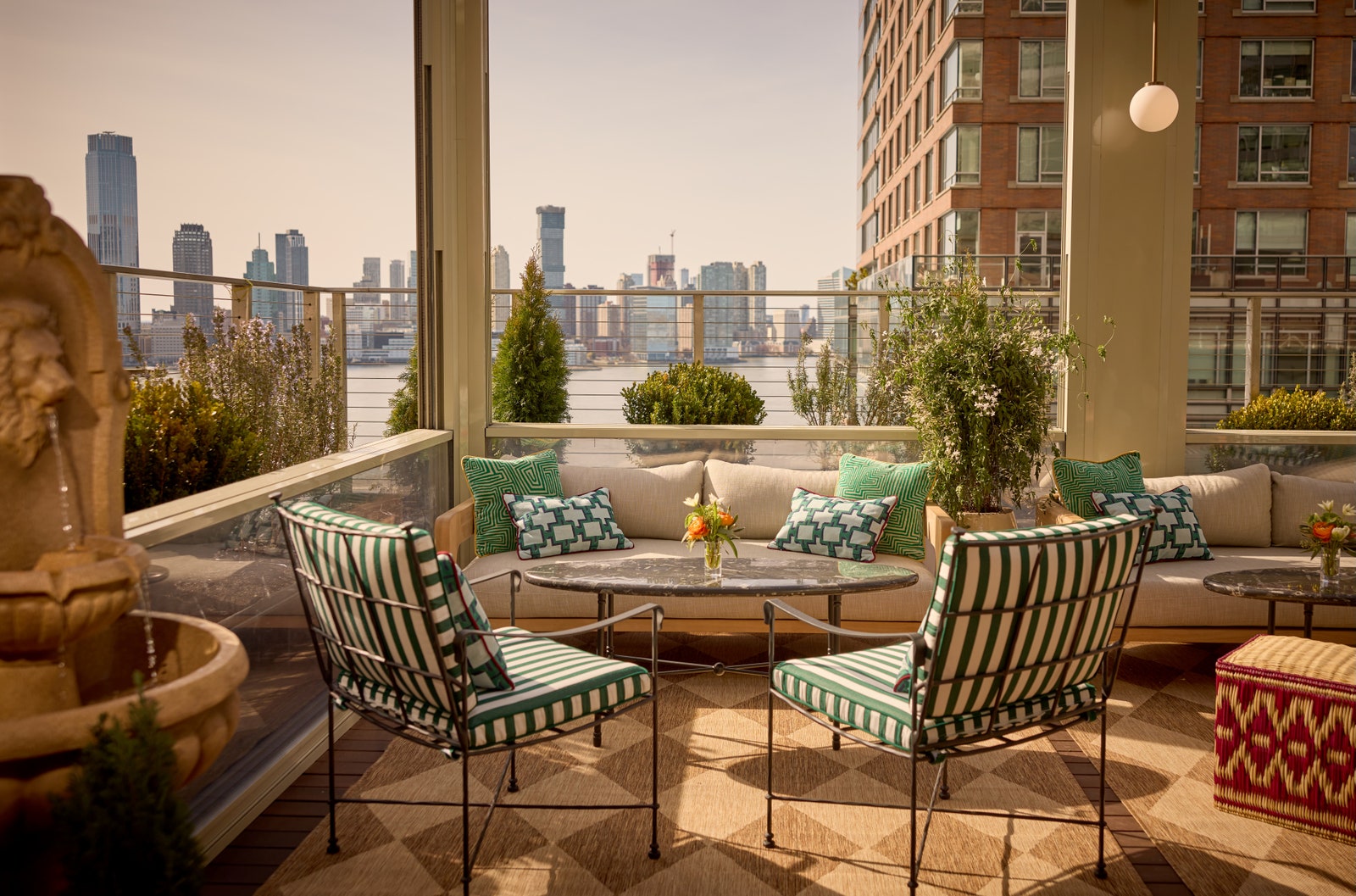 Images may contain architectural balcony building chair furniture city sofa lights and plants