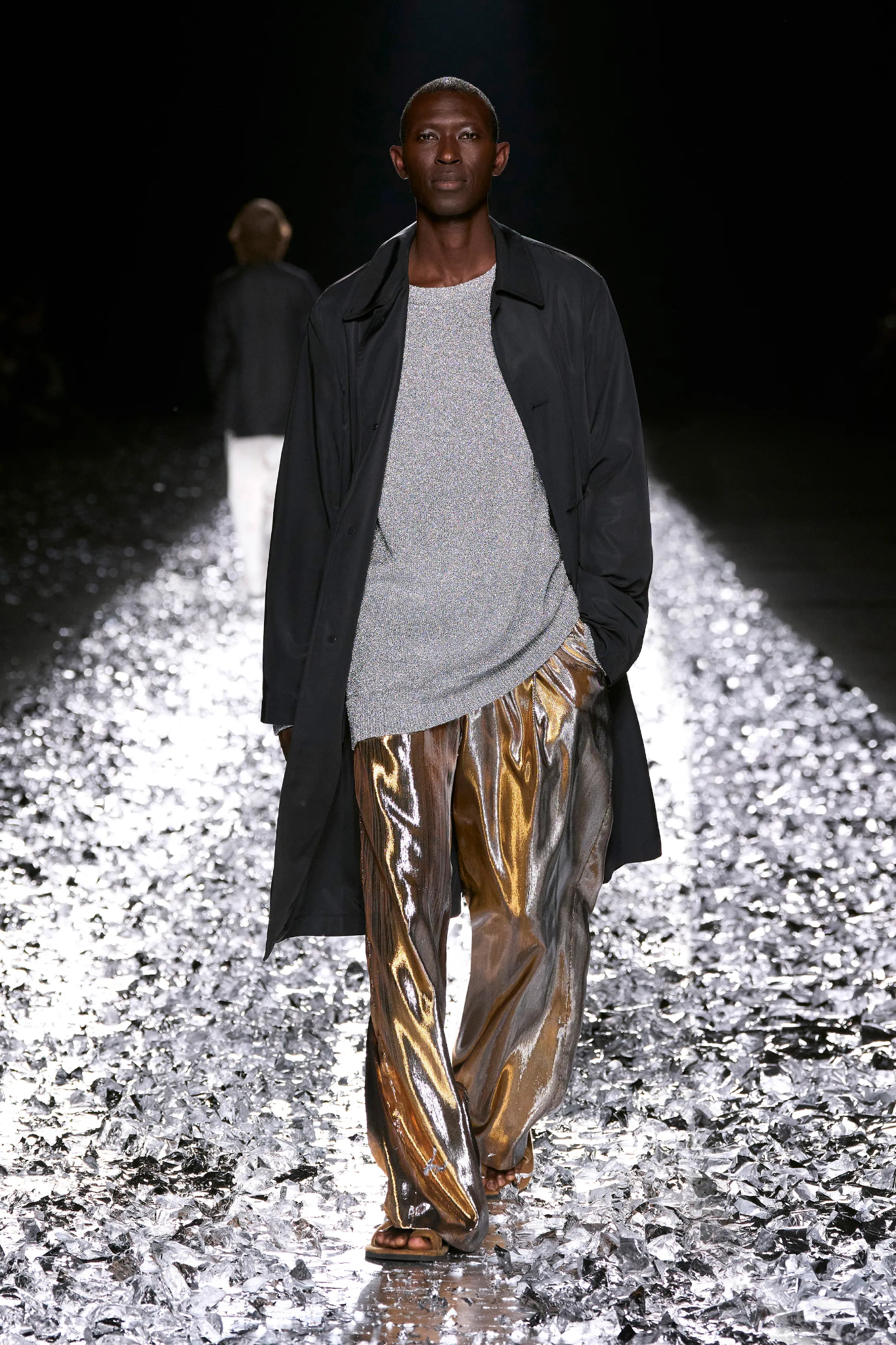 Images may contain a person standing in fashionable clothes walking and adult