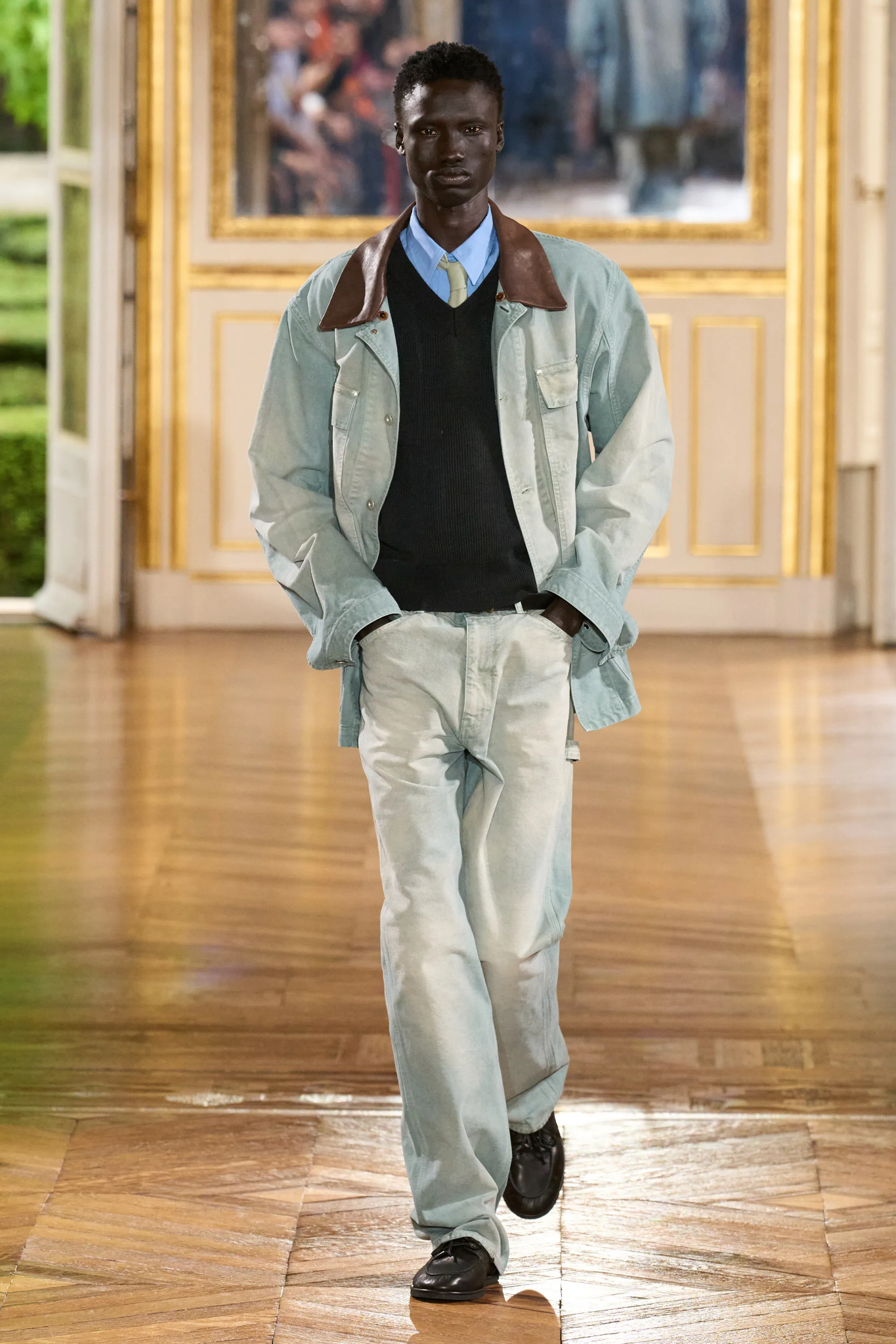 Image may contain adults and pants standing in a man with a coat